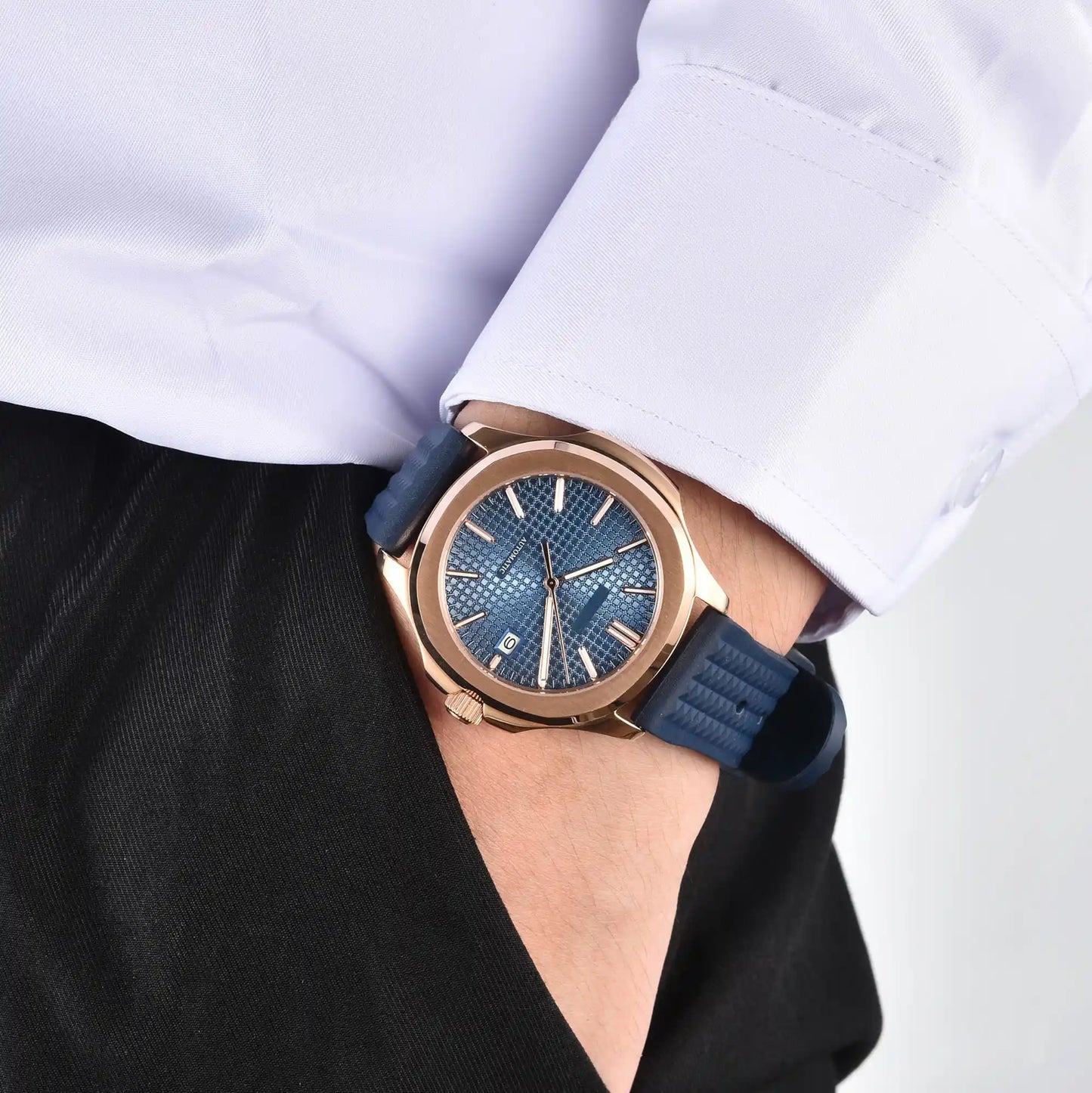 Men's rose gold blue Aquanaut style Seiko mod watch on wrist, casual daily wear lifestyle shot