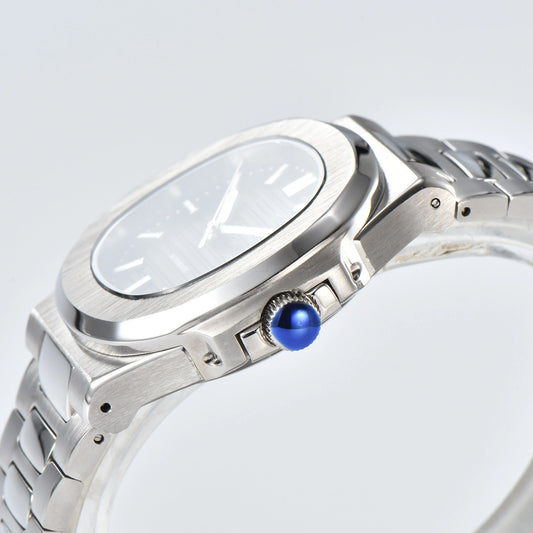 Side view of Nautilus style Seiko mod watch, polished stainless steel case and silver crown detail