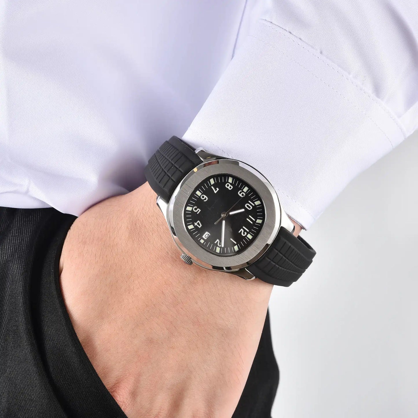 Men's silver black Aquanaut style Seiko mod watch on wrist, casual daily wear lifestyle shot