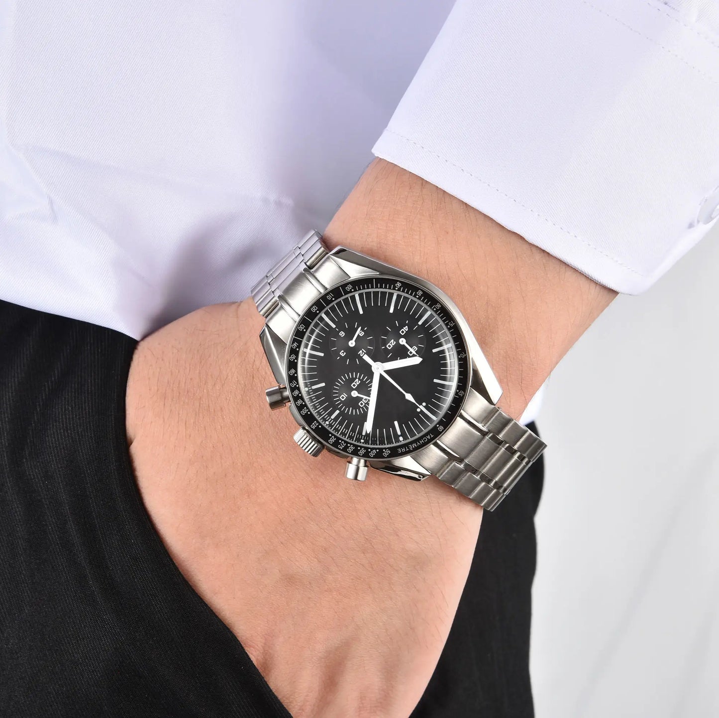 Men's silver chronograph speedmaster Seiko mod watch on wrist, casual daily wear shot