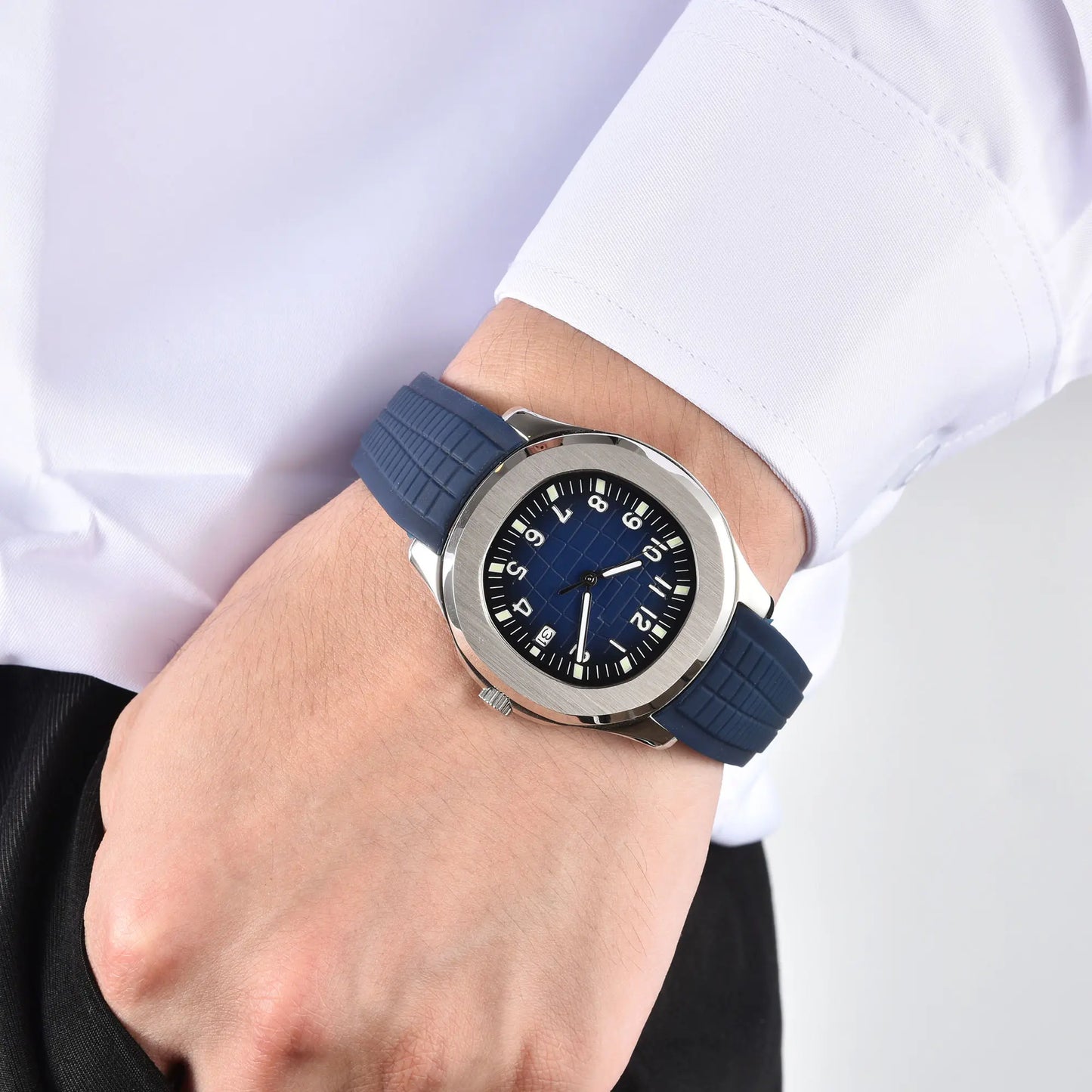 Men's silver blue Aquanaut style Seiko mod watch on wrist, casual daily wear lifestyle shot