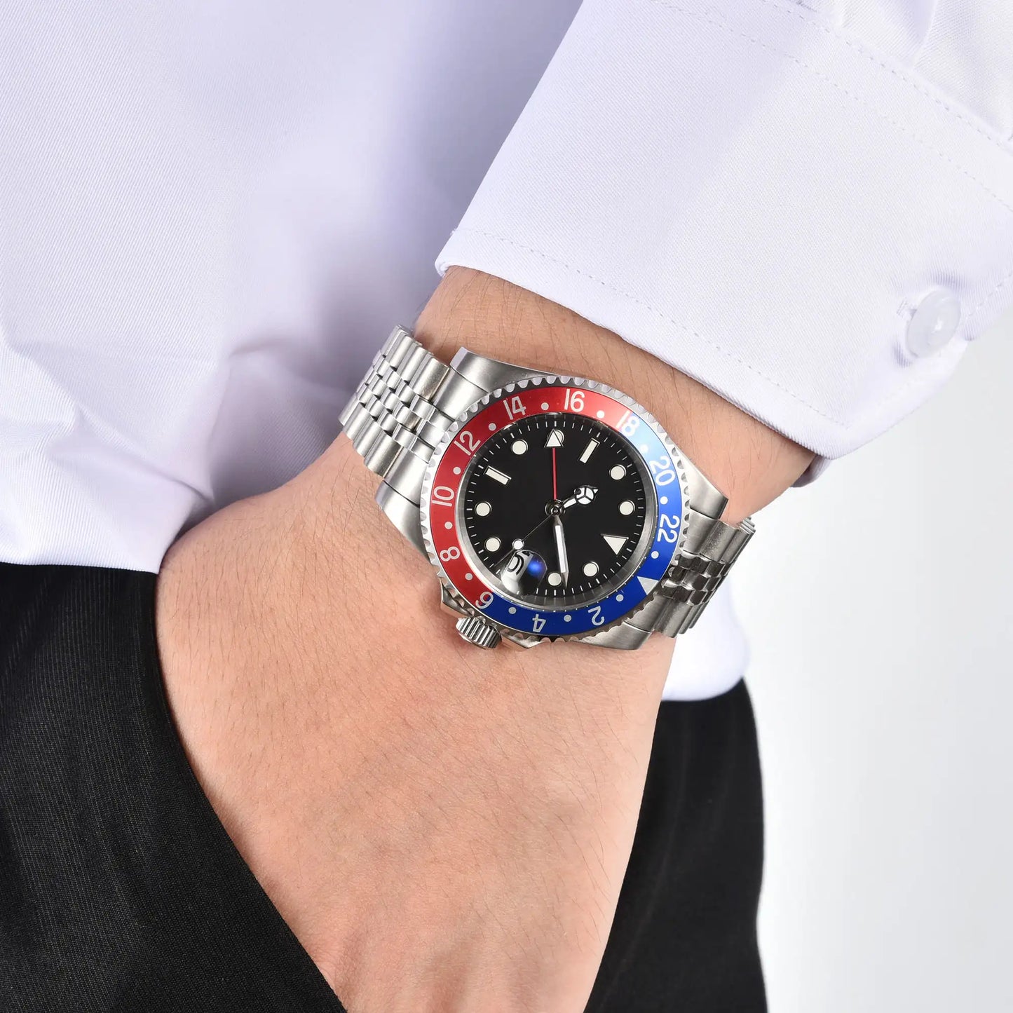 Wrist shot of custom pepsi Seiko mod GMT watch worn with a formal suit, showcasing the polished finish and refined dial details