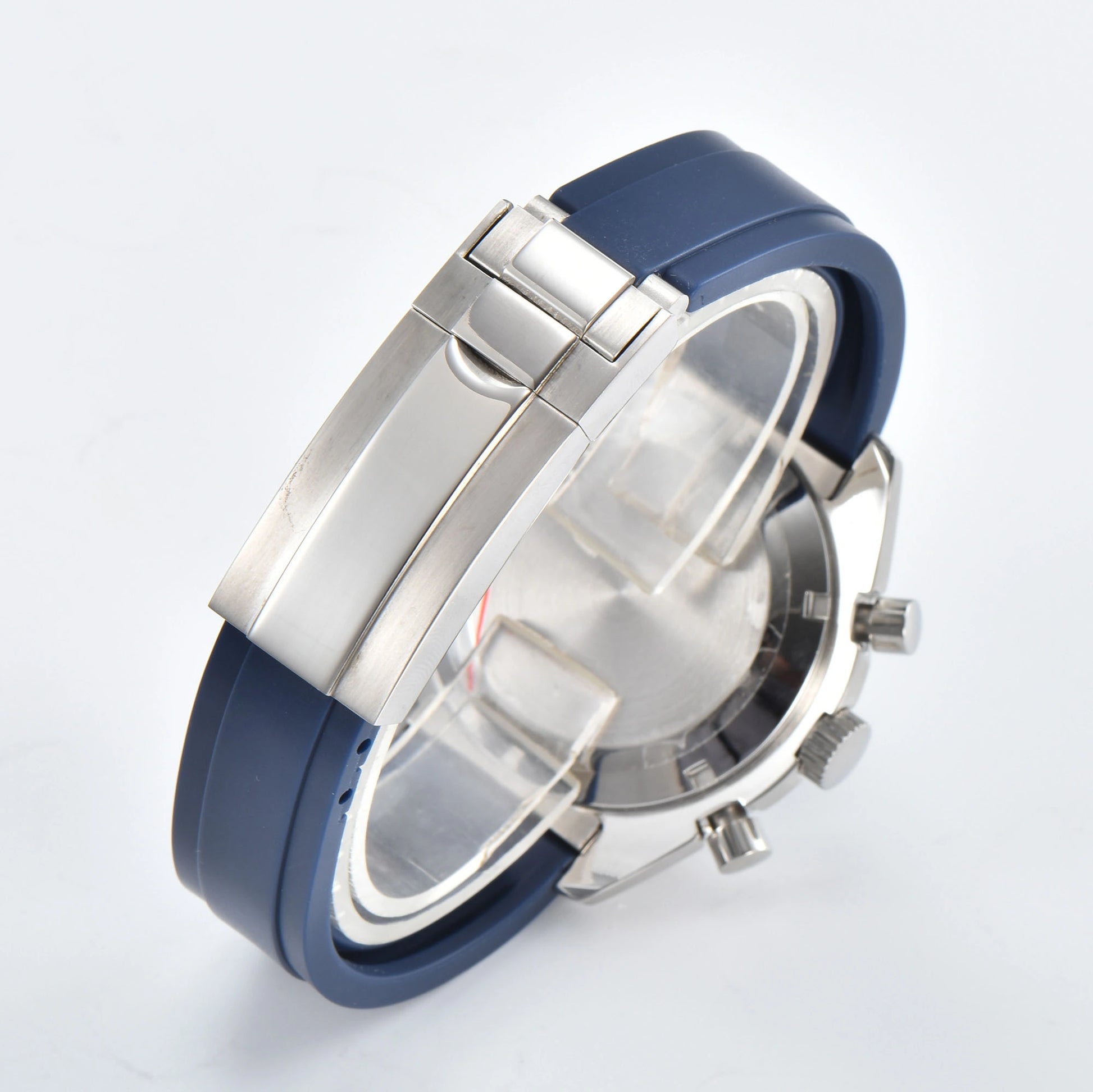 Solid brushed case back of silver chronograph Seiko mod watch, blue rubber strap with safety buckle