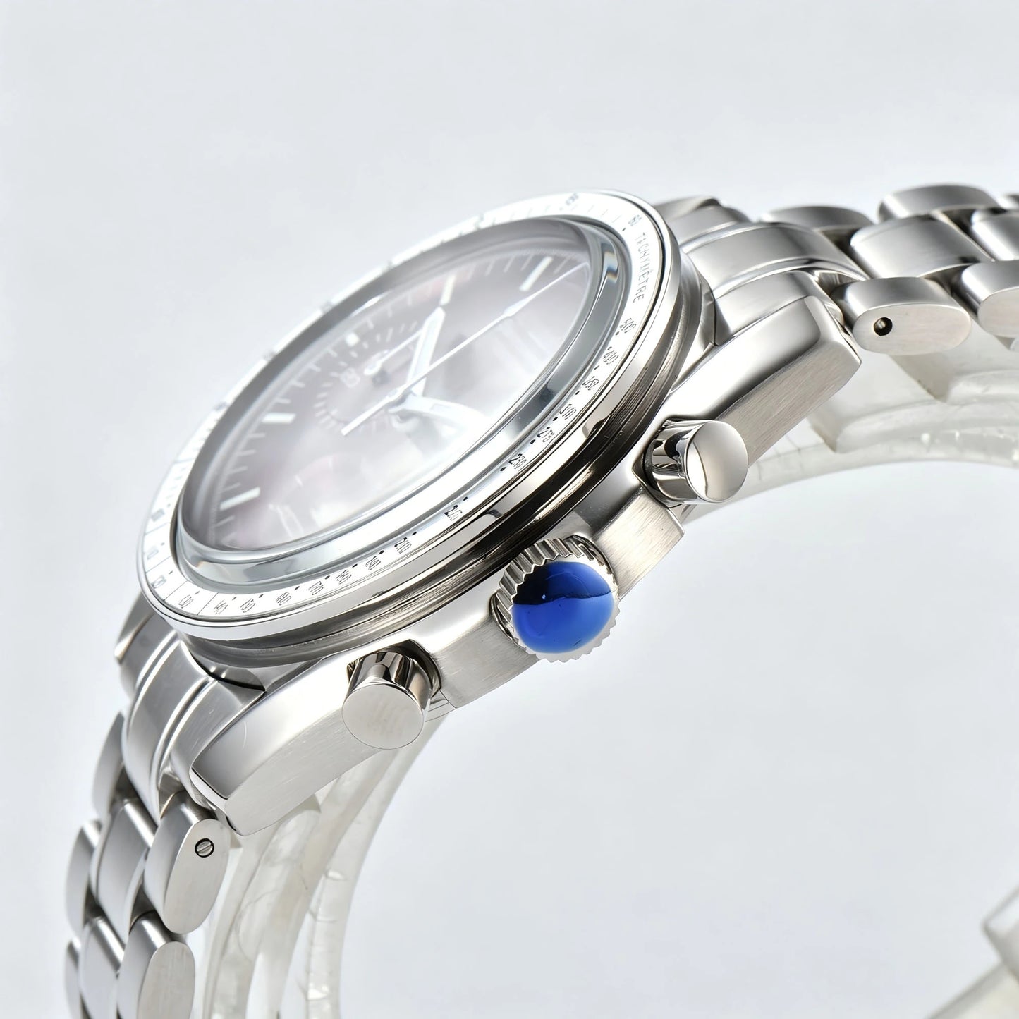 Side view of chronograph style Seiko mod watch, stainless steel pushers and tachymeter bezel detail