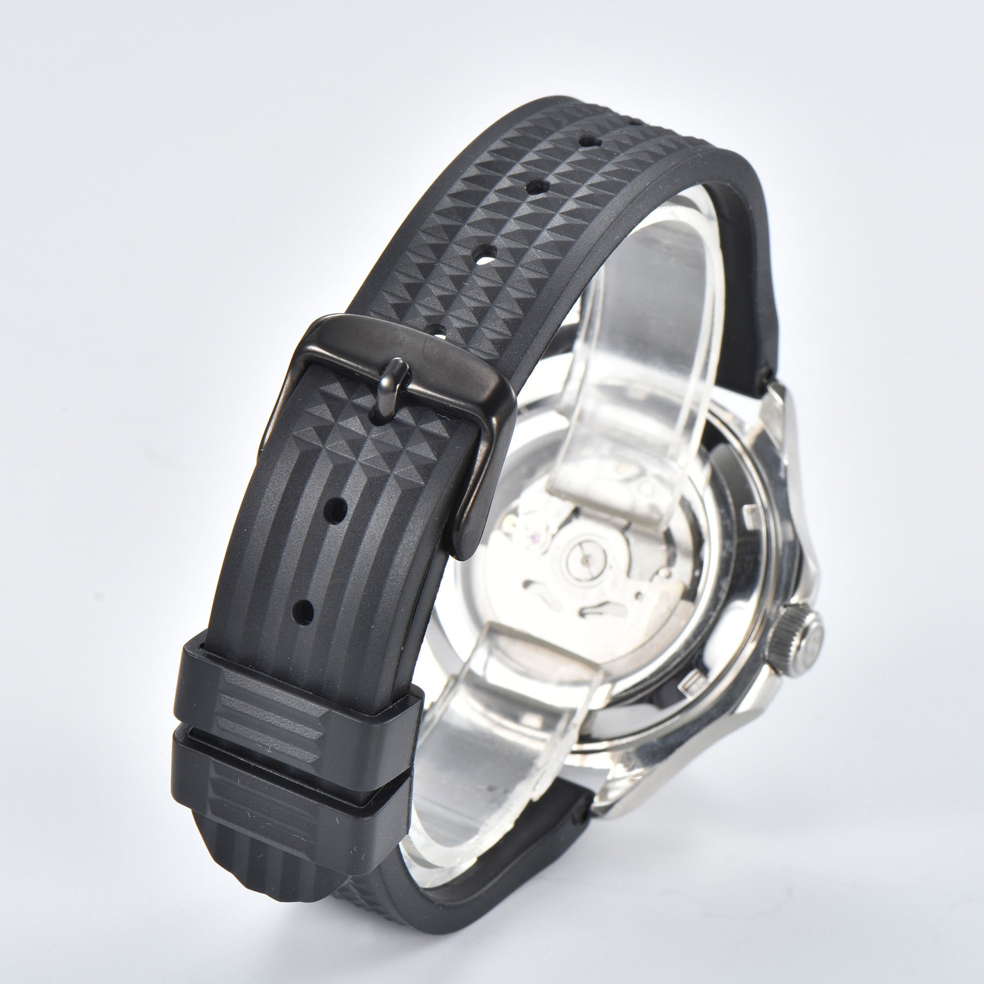 Transparent case back and pin buckle of silver Aquanaut style Seiko mod watch with black rubber strap