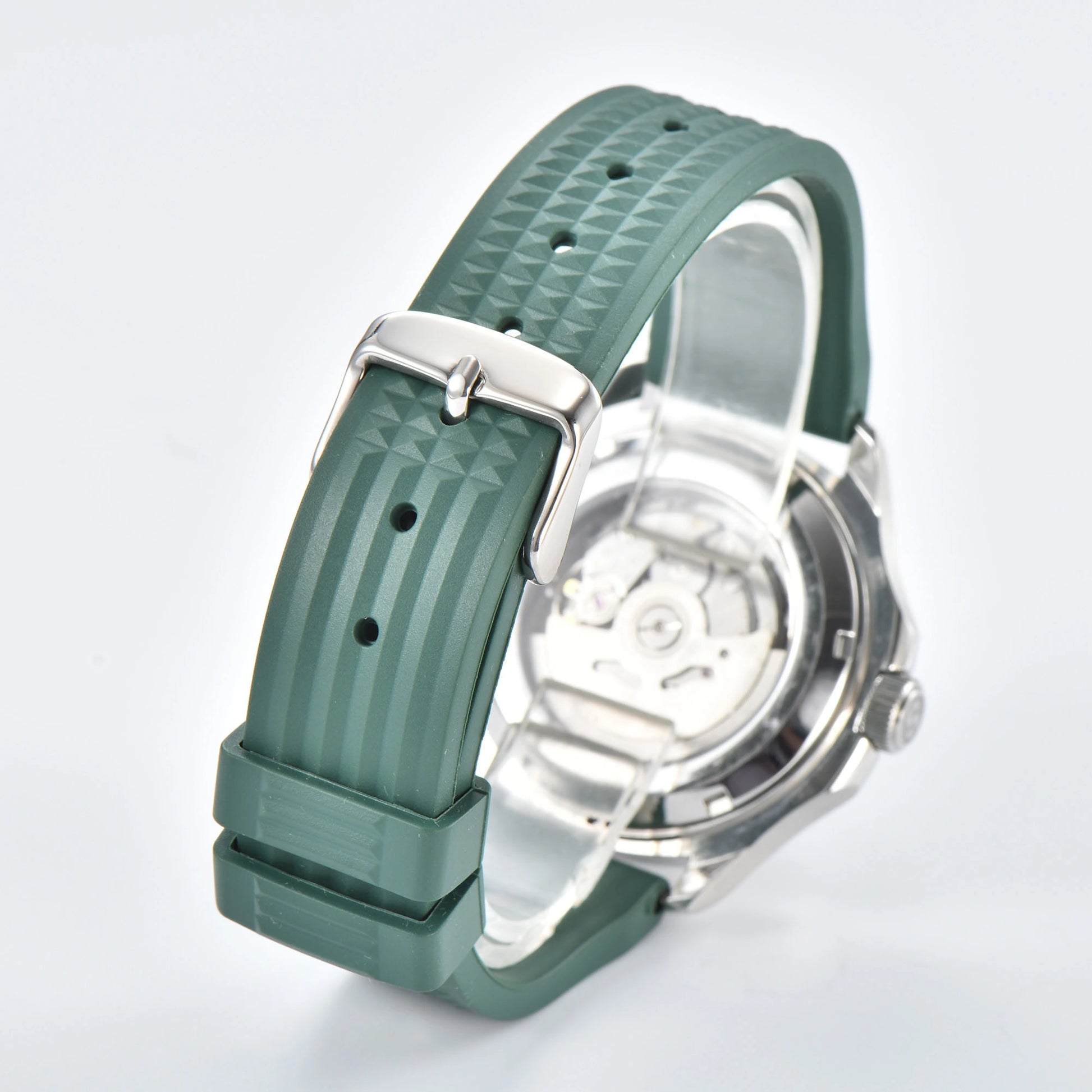 Transparent case back and pin buckle of silver Aquanaut style Seiko mod watch with green rubber strap