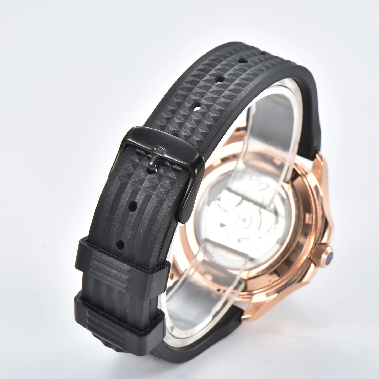Transparent case back and pin buckle of rose gold Aquanaut style Seiko mod watch with black rubber strap