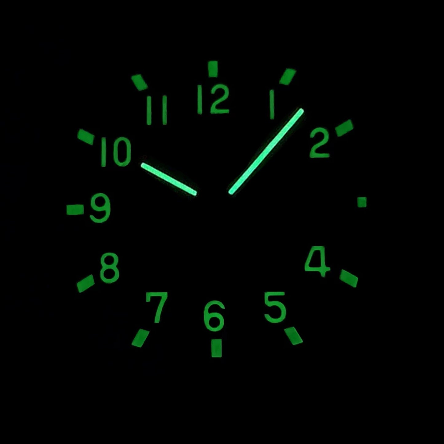 Luminous green dial and hands of rose gold Aquanaut style Seiko mod watch in dark environment