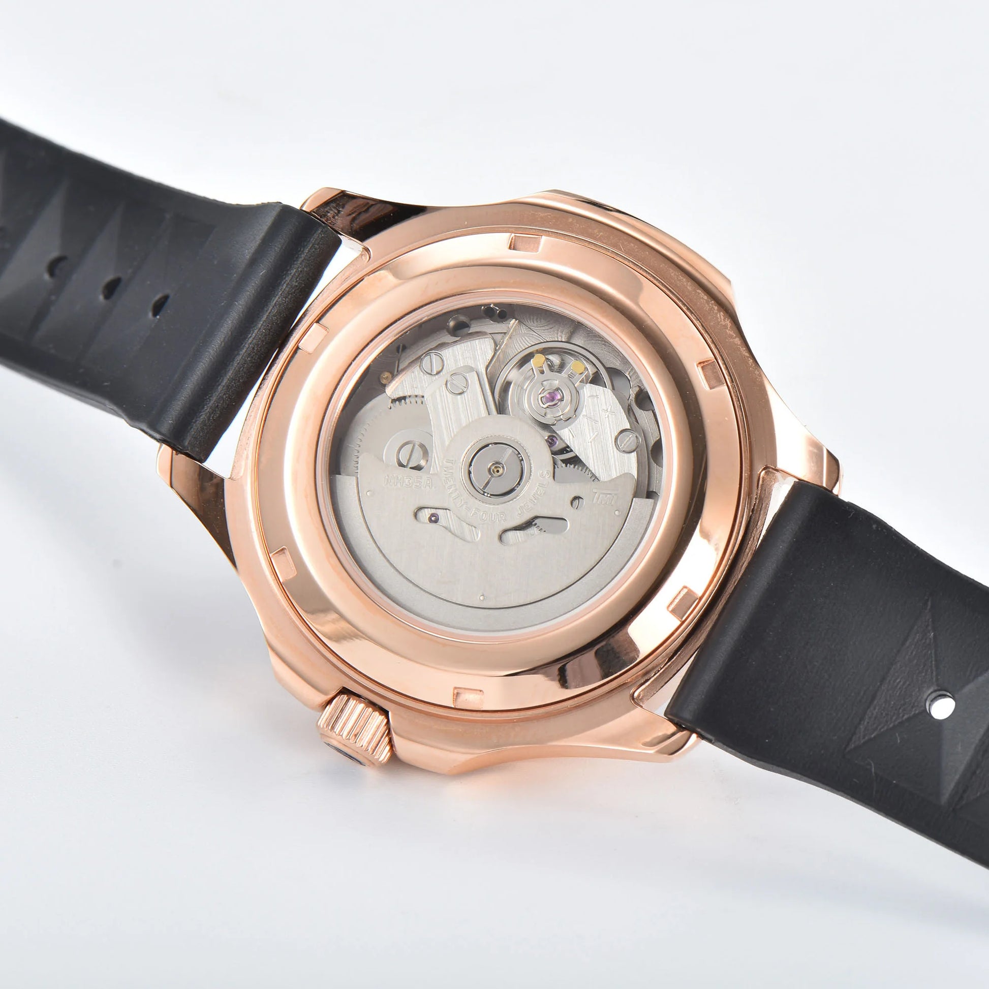 Clear case back showing Seiko NH35 automatic movement in rose gold black Aquanaut style Seiko mod watch