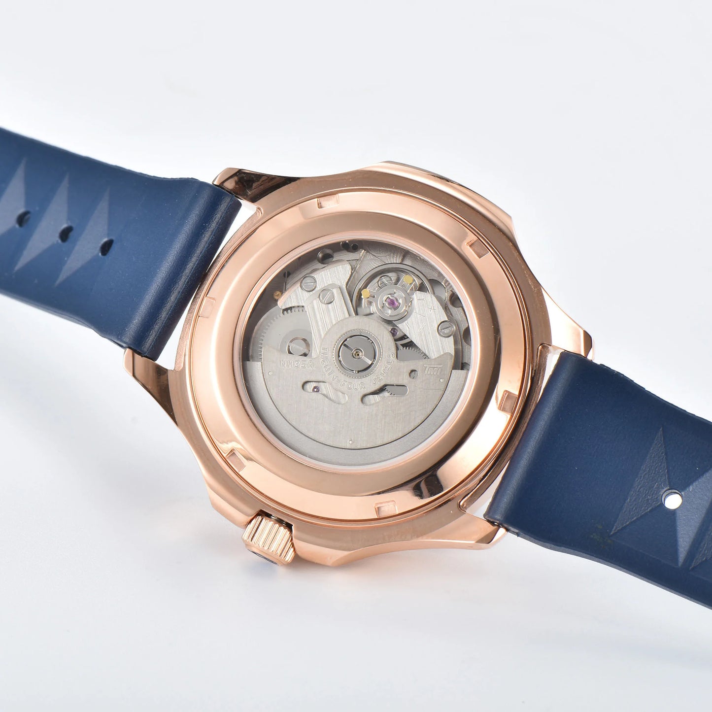 Clear case back showing Seiko NH35 automatic movement in rose gold blue Aquanaut style Seiko mod watch