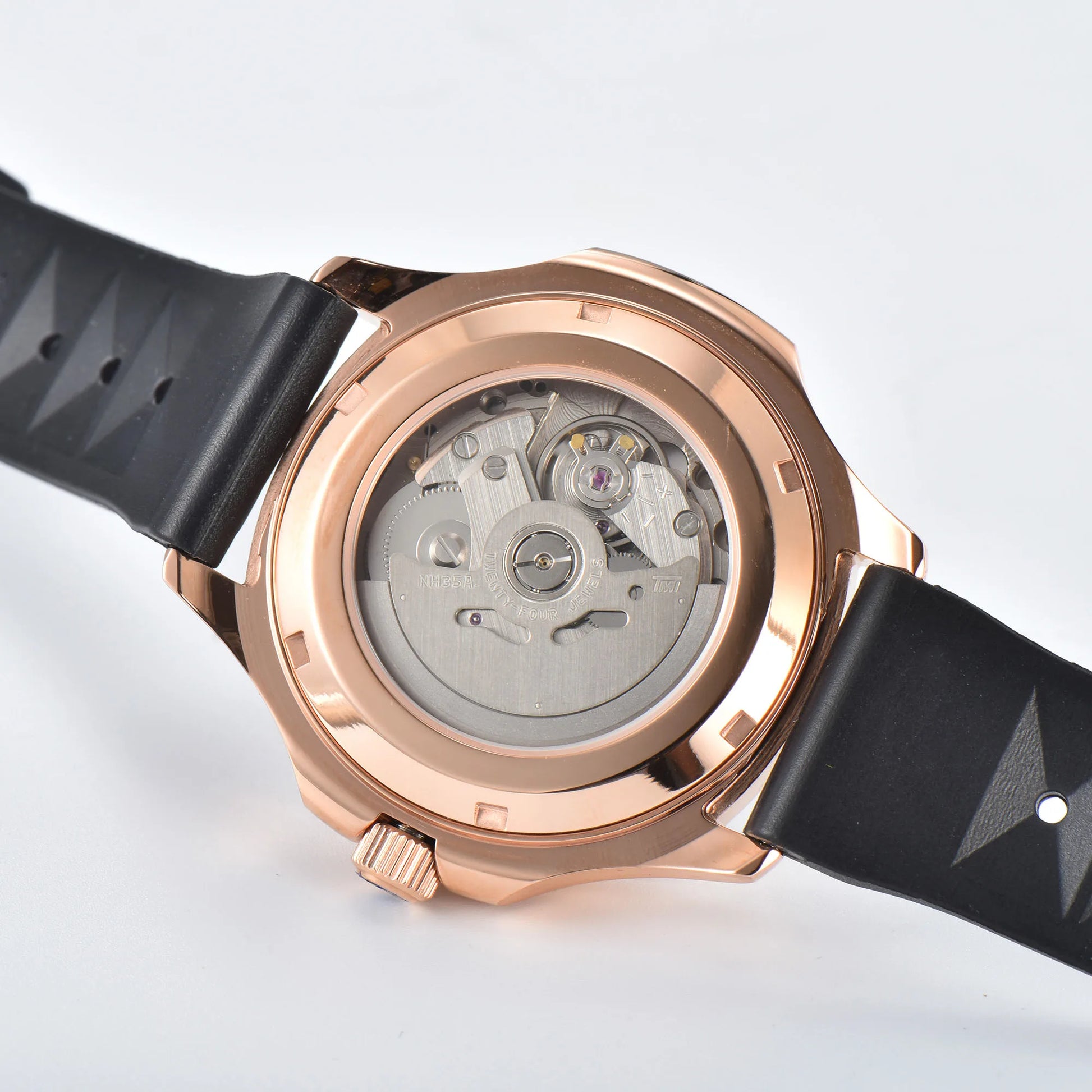 Clear case back showing Seiko NH35 automatic movement in rose gold Aquanaut style Seiko mod watch