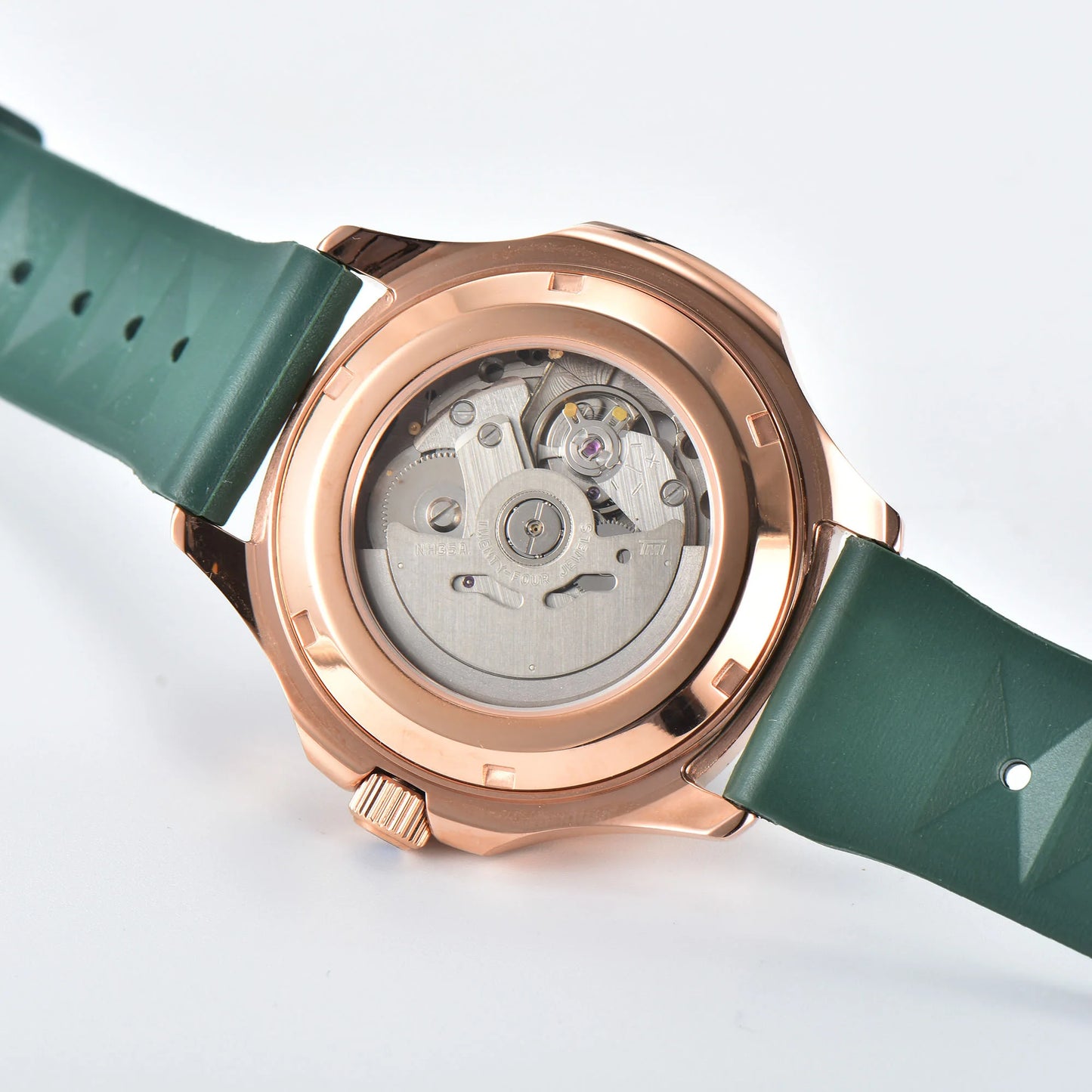 Clear case back showing Seiko NH35 automatic movement in rose gold green Aquanaut style Seiko mod watch