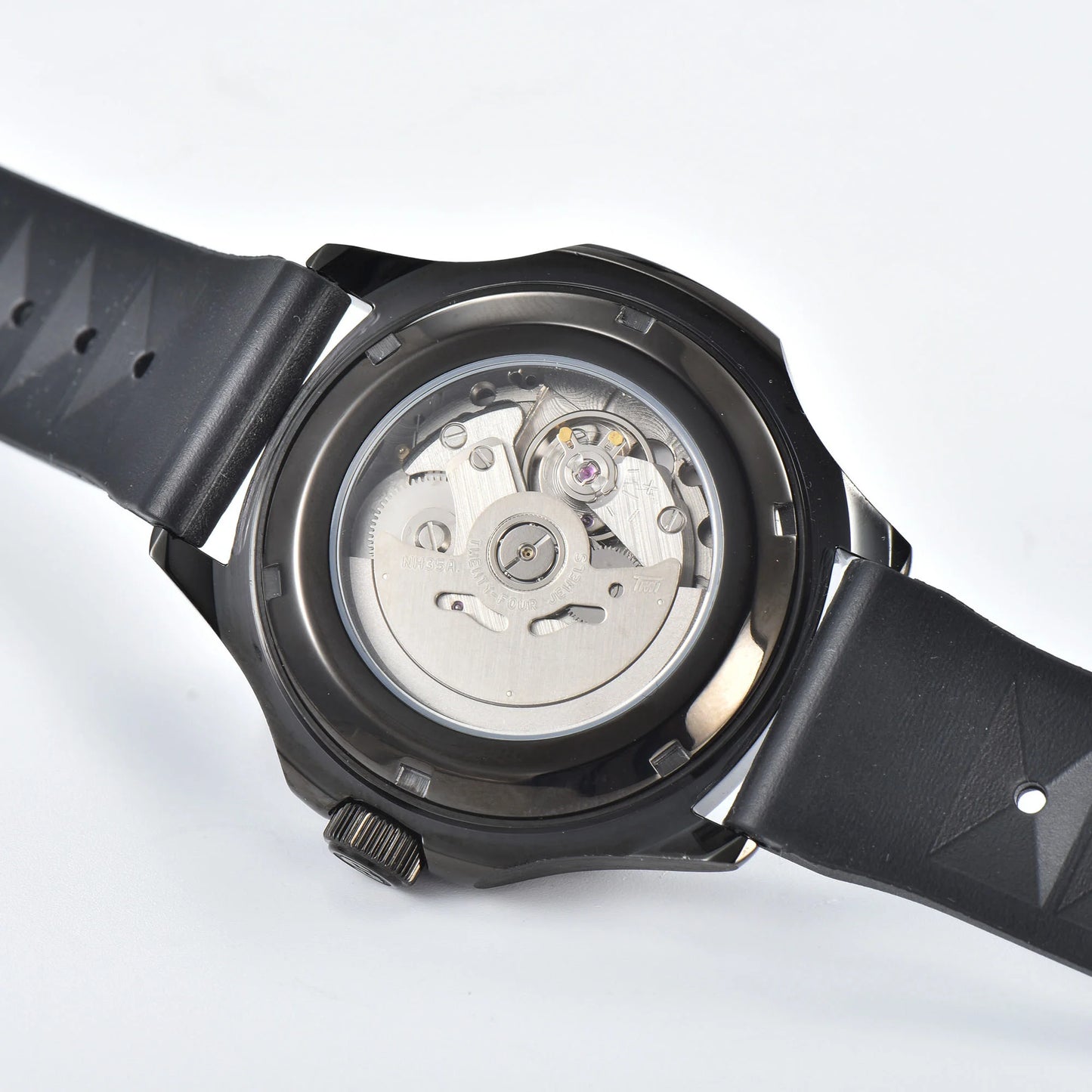 Clear case back showing Seiko NH35 automatic movement in full-black Aquanaut style Seiko mod watch