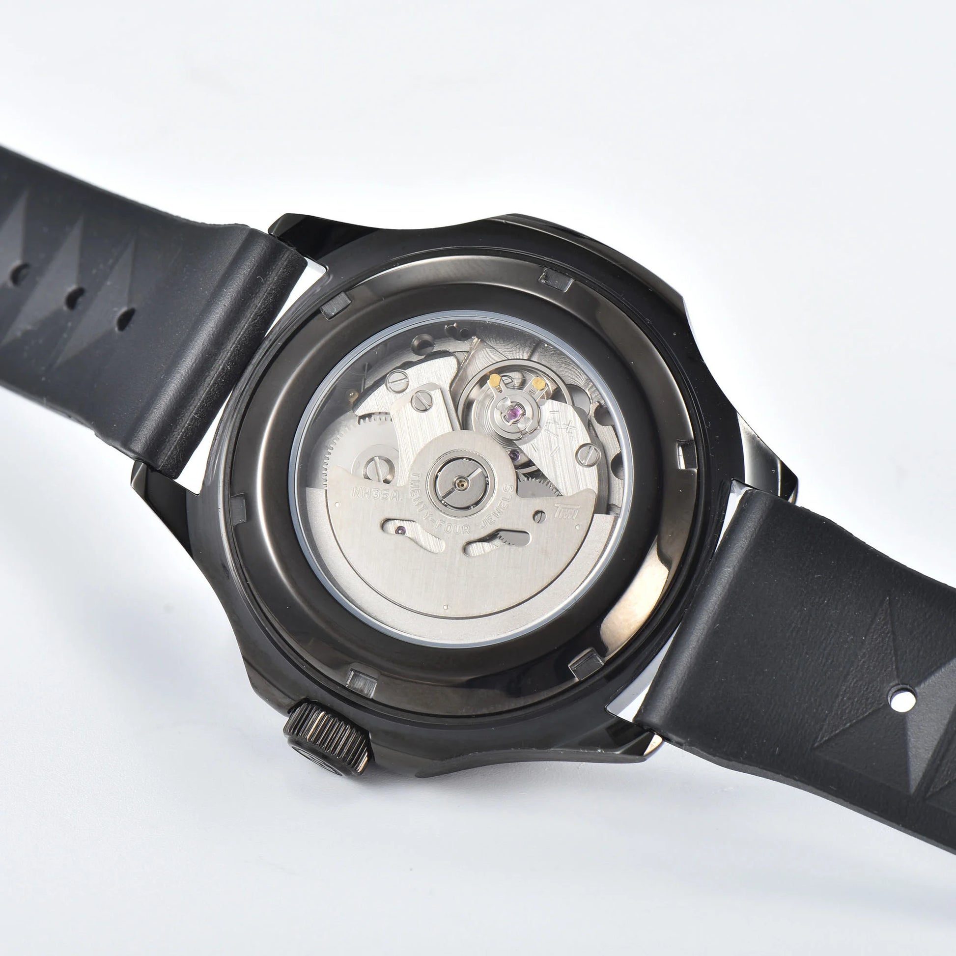 Clear case back showing Seiko NH35 automatic movement in full-black Aquanaut style Seiko mod watch