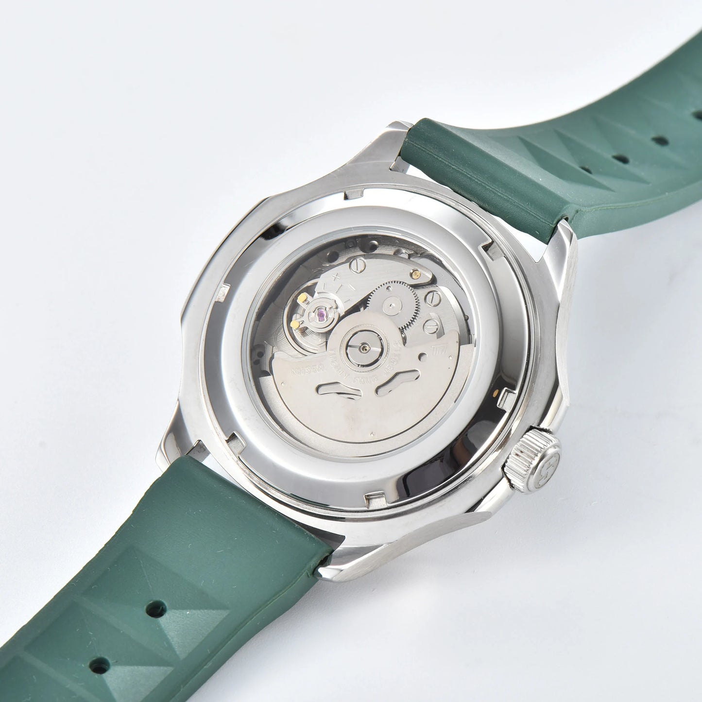 Clear case back showing Seiko NH35 automatic movement in silver green Aquanaut style Seiko mod watch