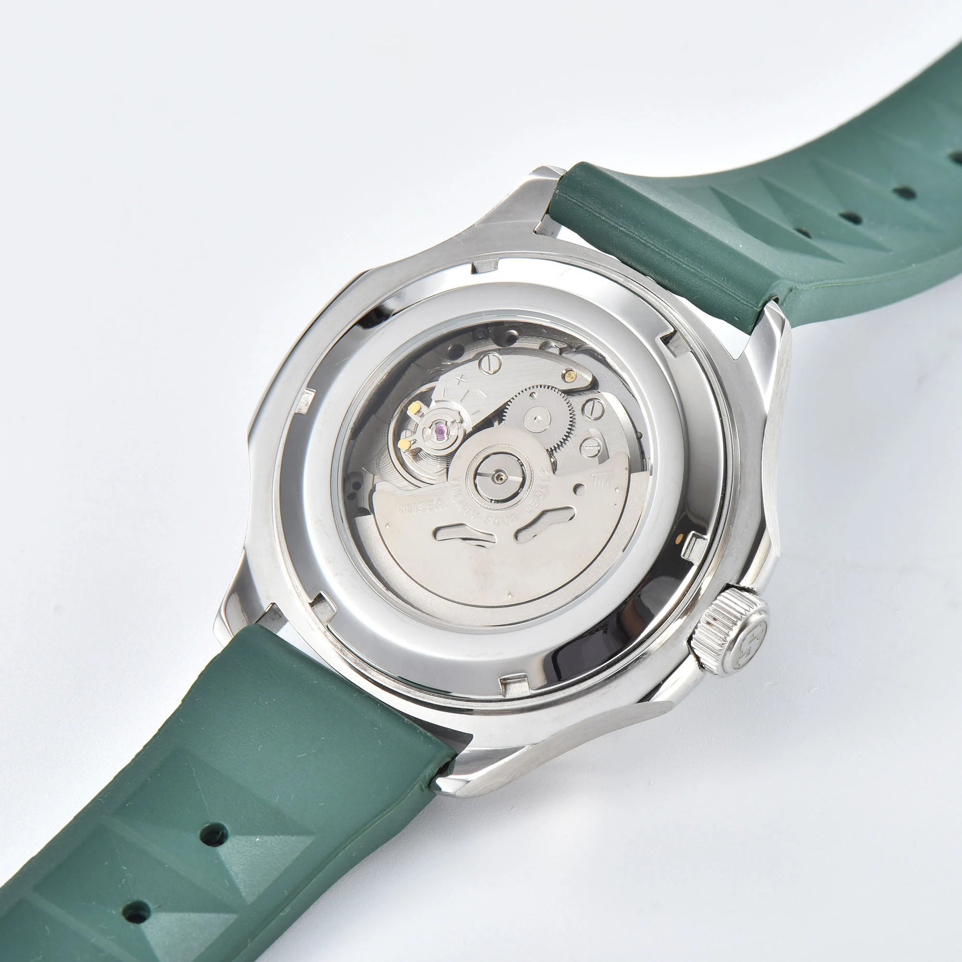 Clear case back showing Seiko NH35 automatic movement in silver green Aquanaut style Seiko mod watch