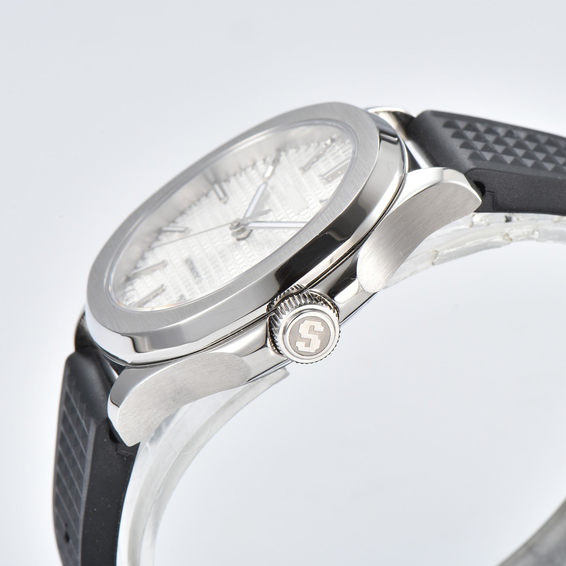 Side view of silver white Aquanaut style Seiko mod watch, polished stainless steel case and crown detail