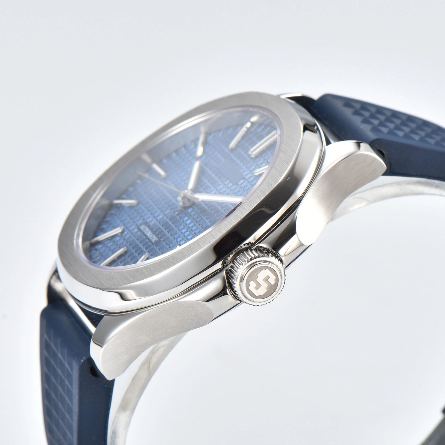 Side view of silver blue Aquanaut style Seiko mod watch, polished stainless steel case and crown detail