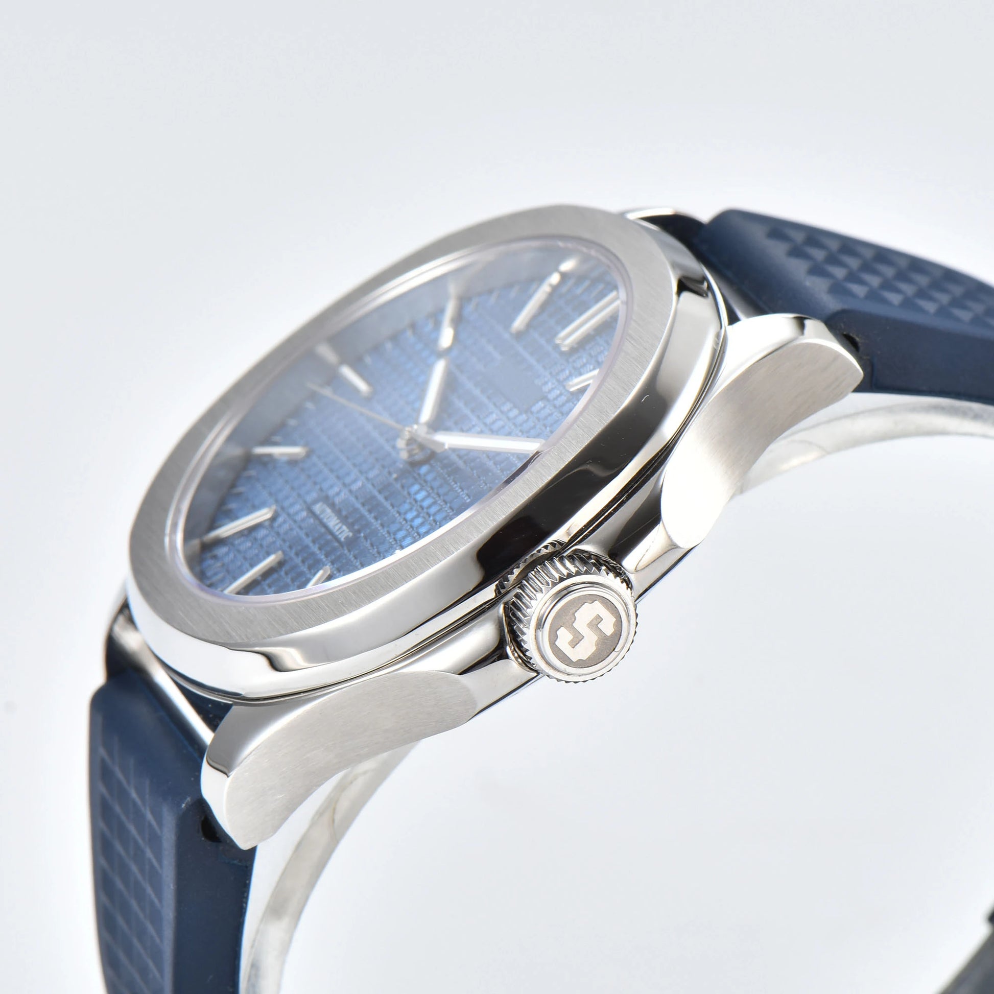 Side view of silver blue Aquanaut style Seiko mod watch, polished stainless steel case and crown detail