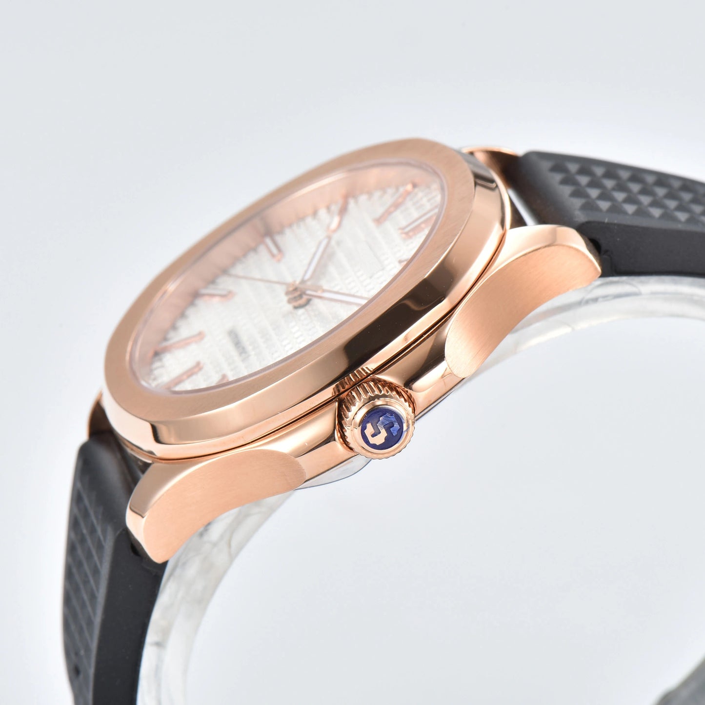 Side view of rose gold white Aquanaut style Seiko mod watch, polished stainless steel case and crown detail