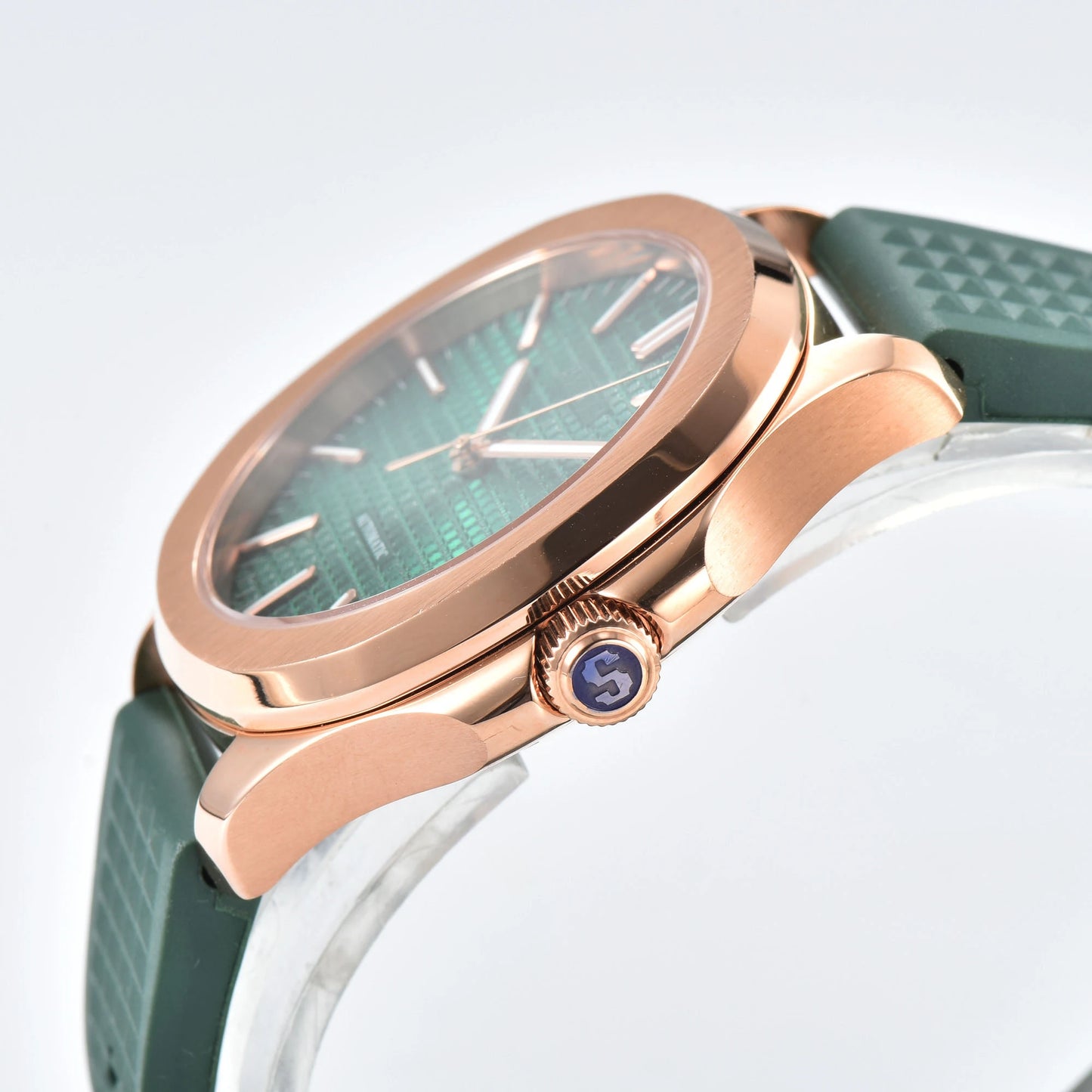 Side view of rose gold green Aquanaut style Seiko mod watch, polished stainless steel case and crown detail