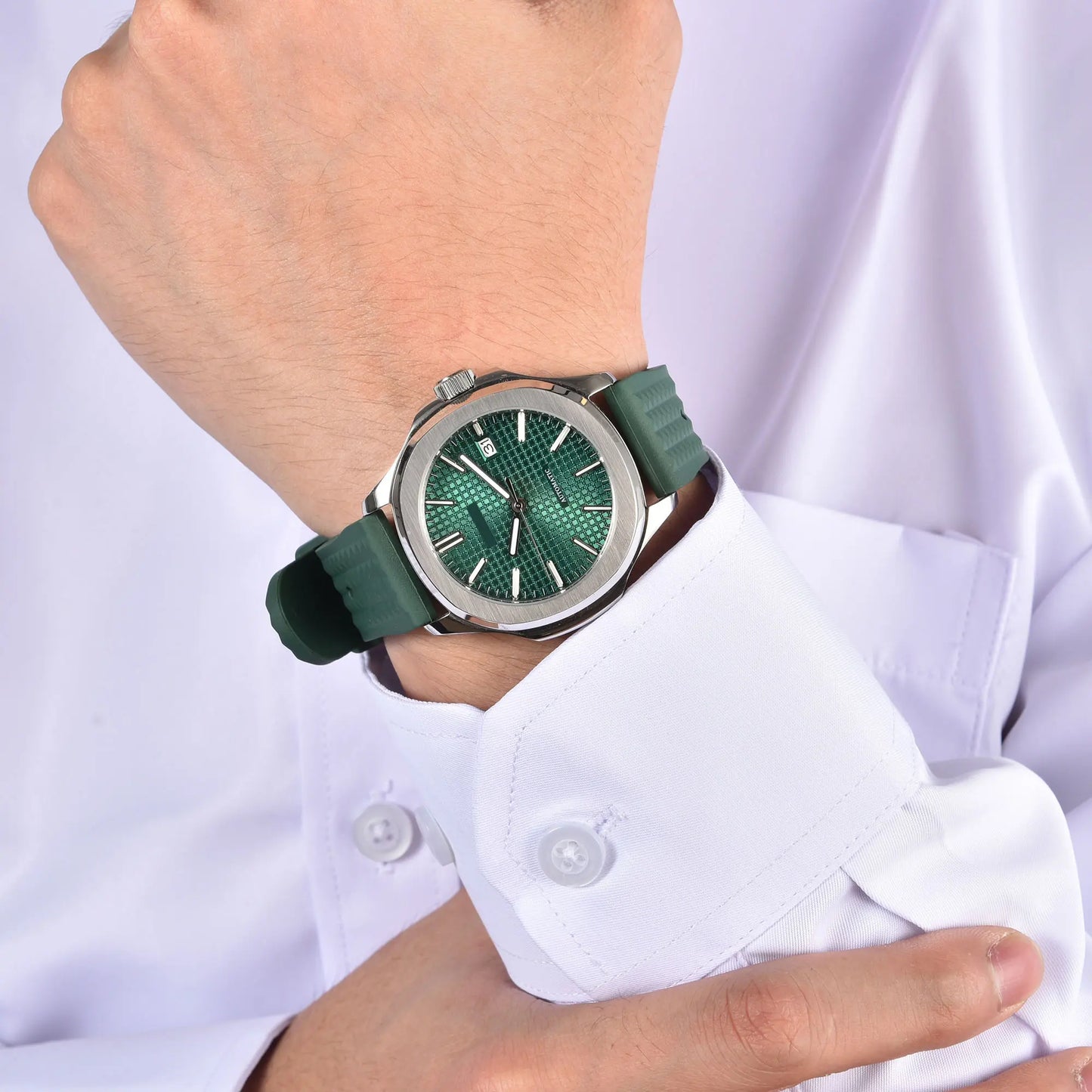 Silver Aquanaut style Seiko mod watch with green rubber strap on wrist, business lifestyle shot
