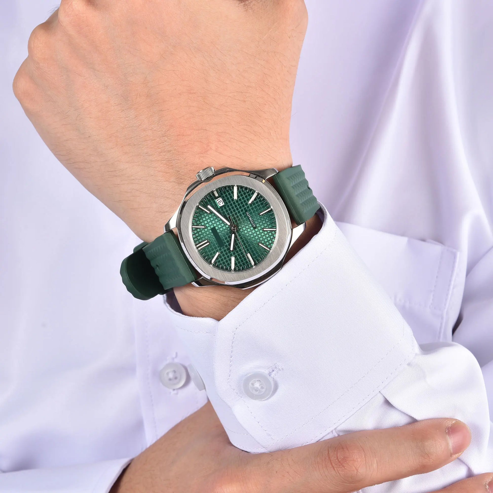Silver Aquanaut style Seiko mod watch with green rubber strap on wrist, business lifestyle shot