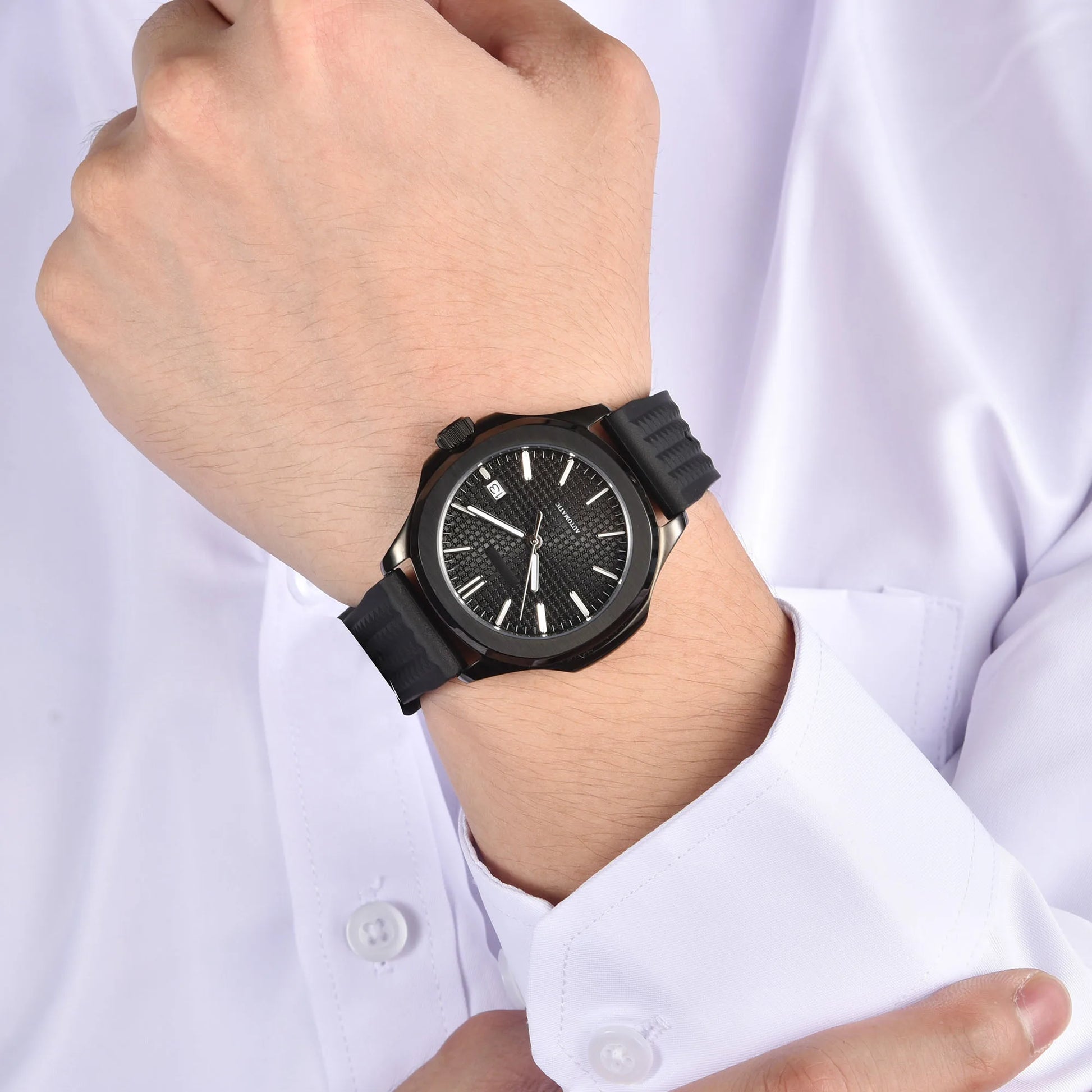 Stealth black Aquanaut style Seiko mod watch with black rubber strap on wrist, business lifestyle shot