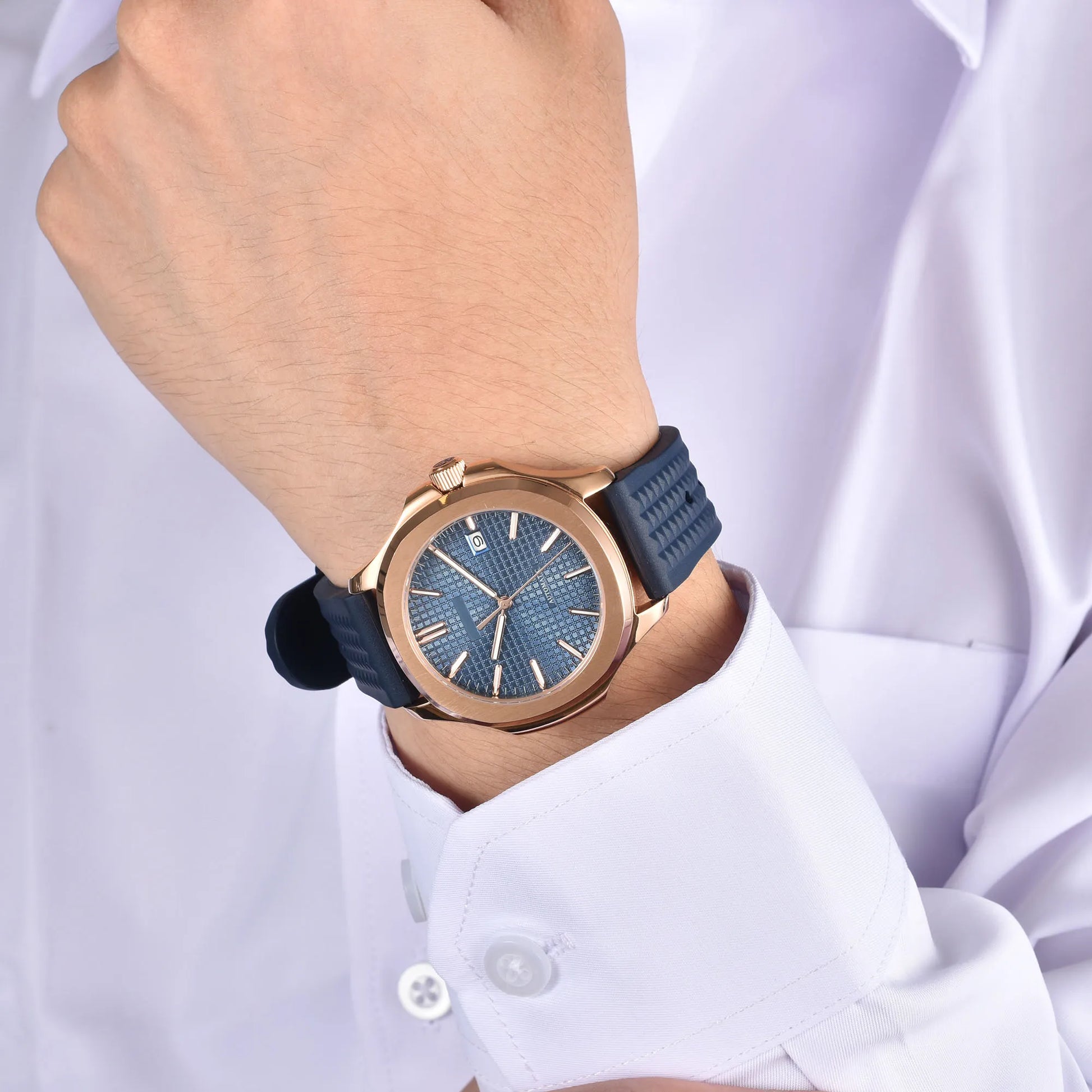 Rose gold Aquanaut style Seiko mod watch with blue rubber strap on wrist, business lifestyle shot