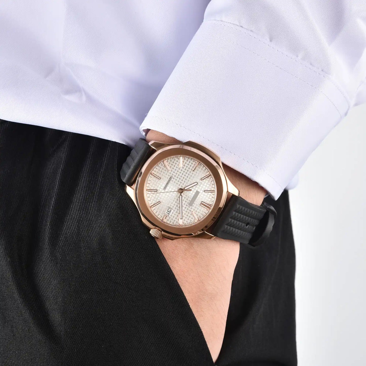 Men's rose gold white Aquanaut style Seiko mod watch on wrist, casual daily wear lifestyle shot