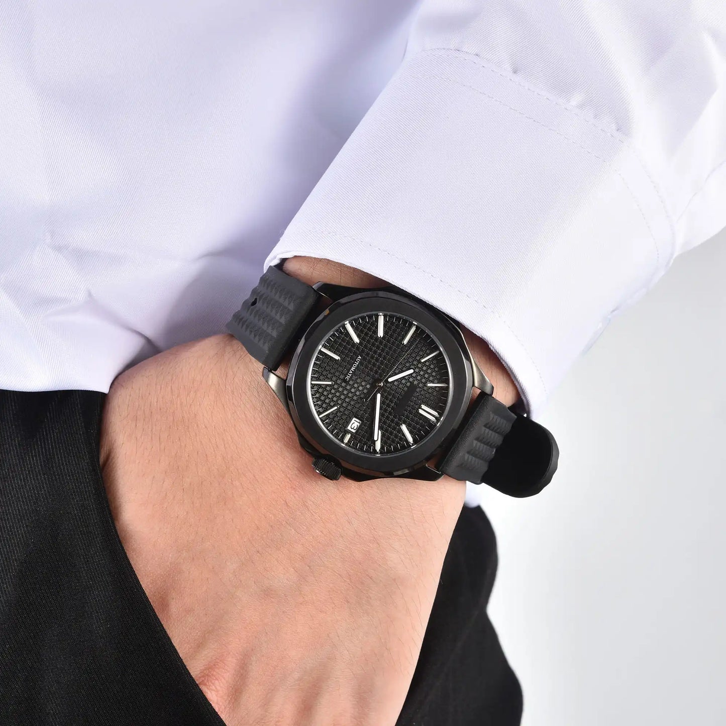 Men's stealth black Aquanaut style Seiko mod watch on wrist, casual daily wear lifestyle shot