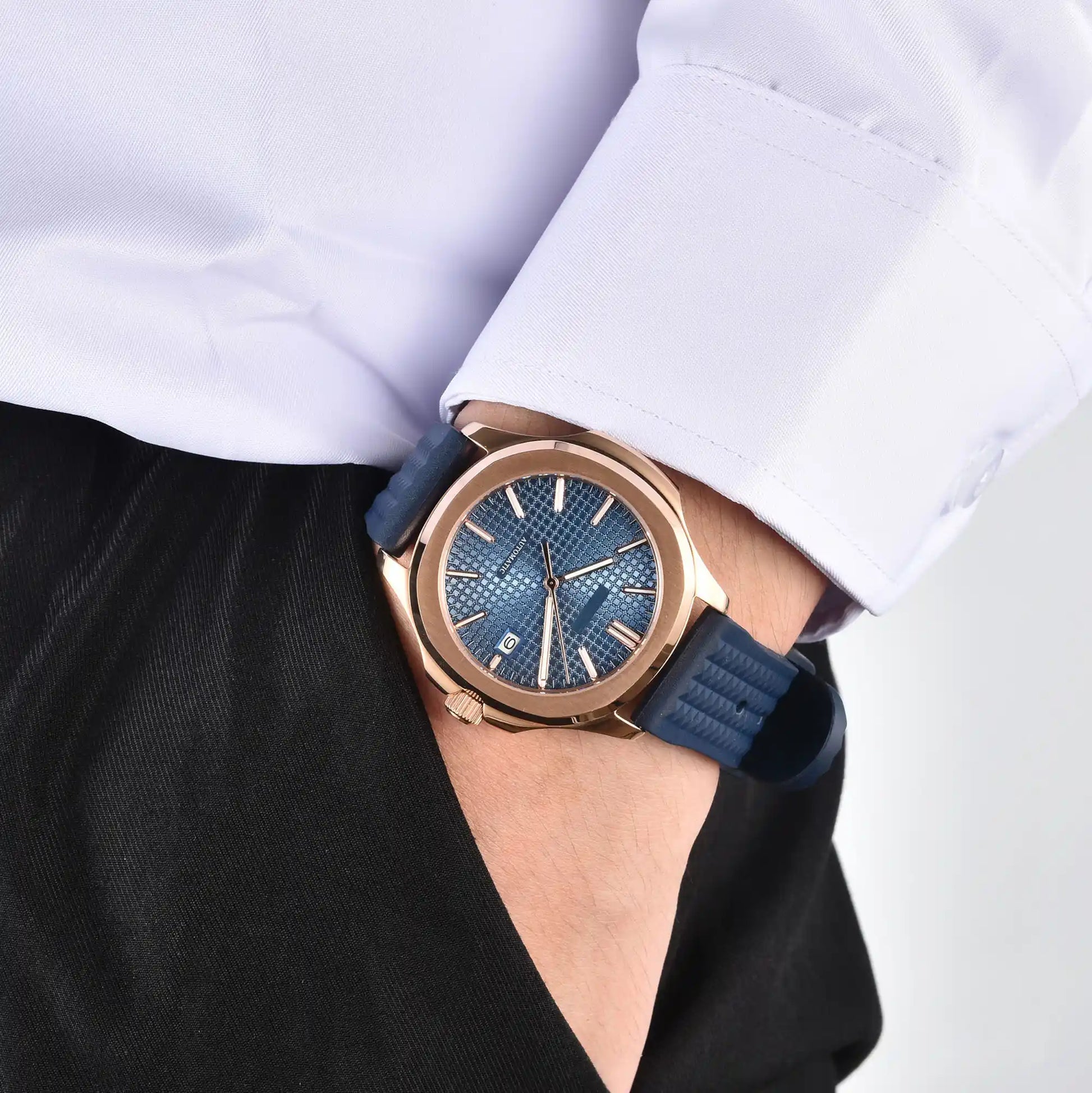 Men's rose gold blue Aquanaut style Seiko mod watch on wrist, casual daily wear lifestyle shot