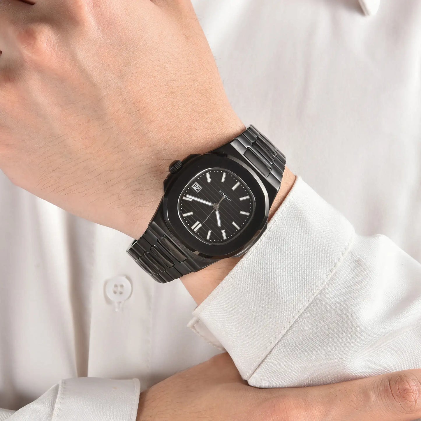 Full black Nautilus style Seiko mod watch with stainless steel bracelet on wrist, business lifestyle shot
