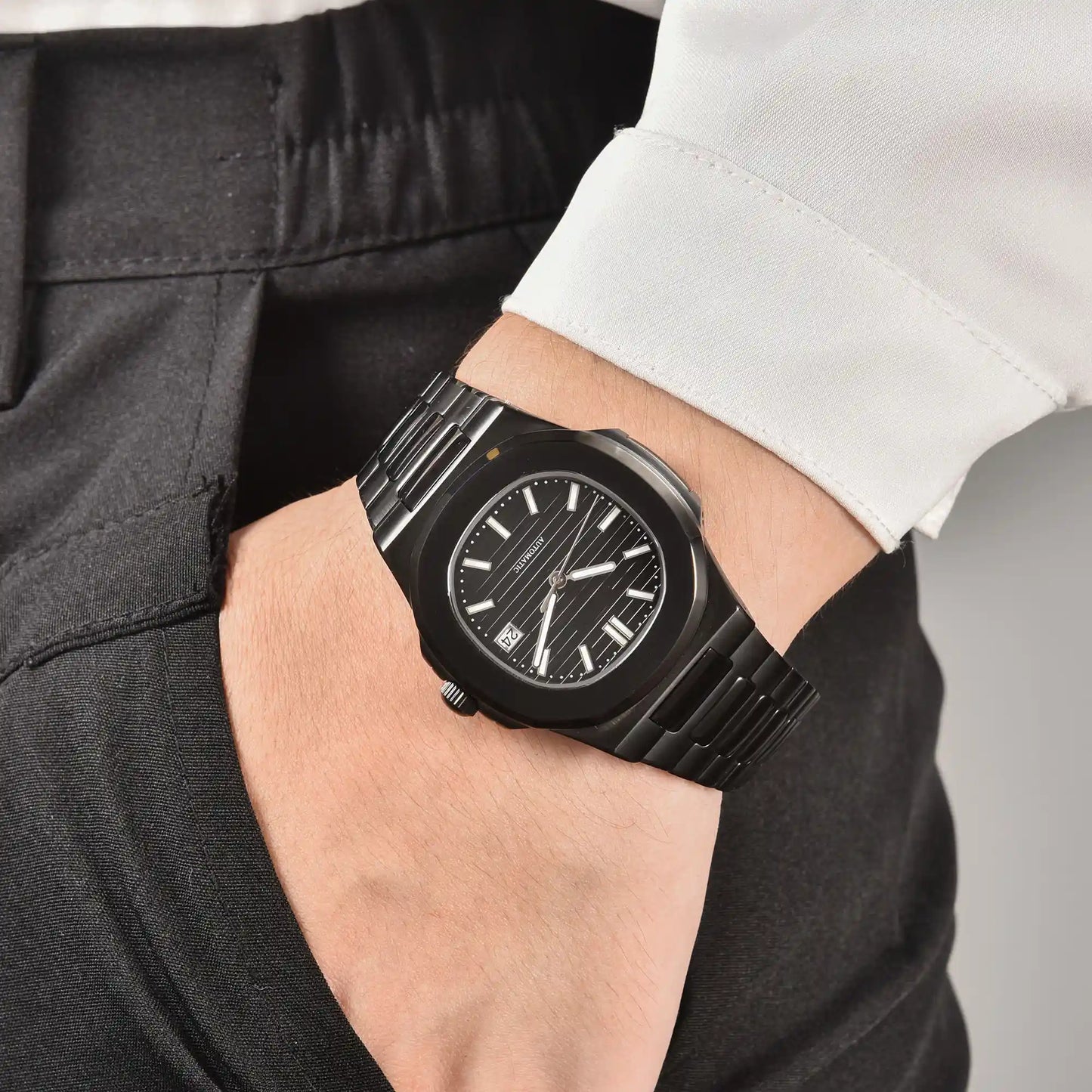Men's full black Nautilus style Seiko mod watch on wrist, casual daily wear lifestyle shot