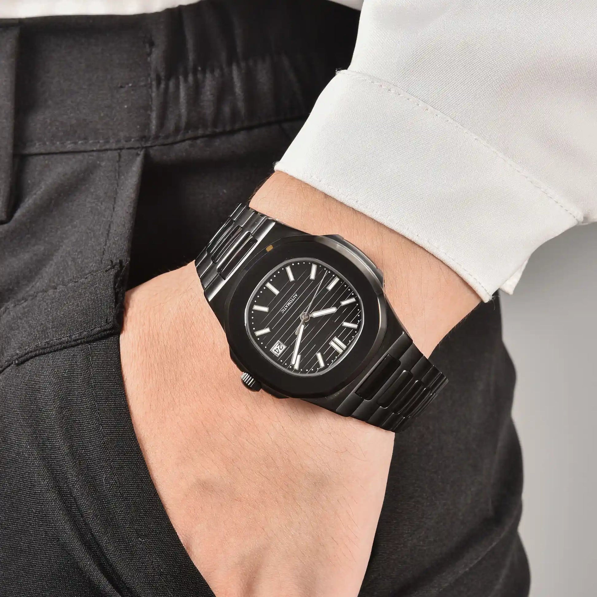 Men's full black Nautilus style Seiko mod watch on wrist, casual daily wear lifestyle shot