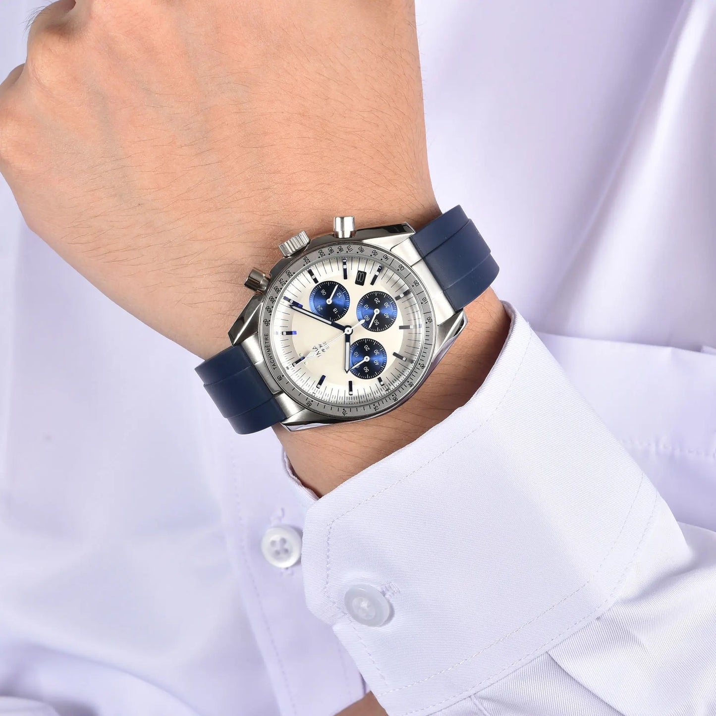 Silver blue chronograph speedmaster style Seiko mod watch on wrist, business lifestyle shot