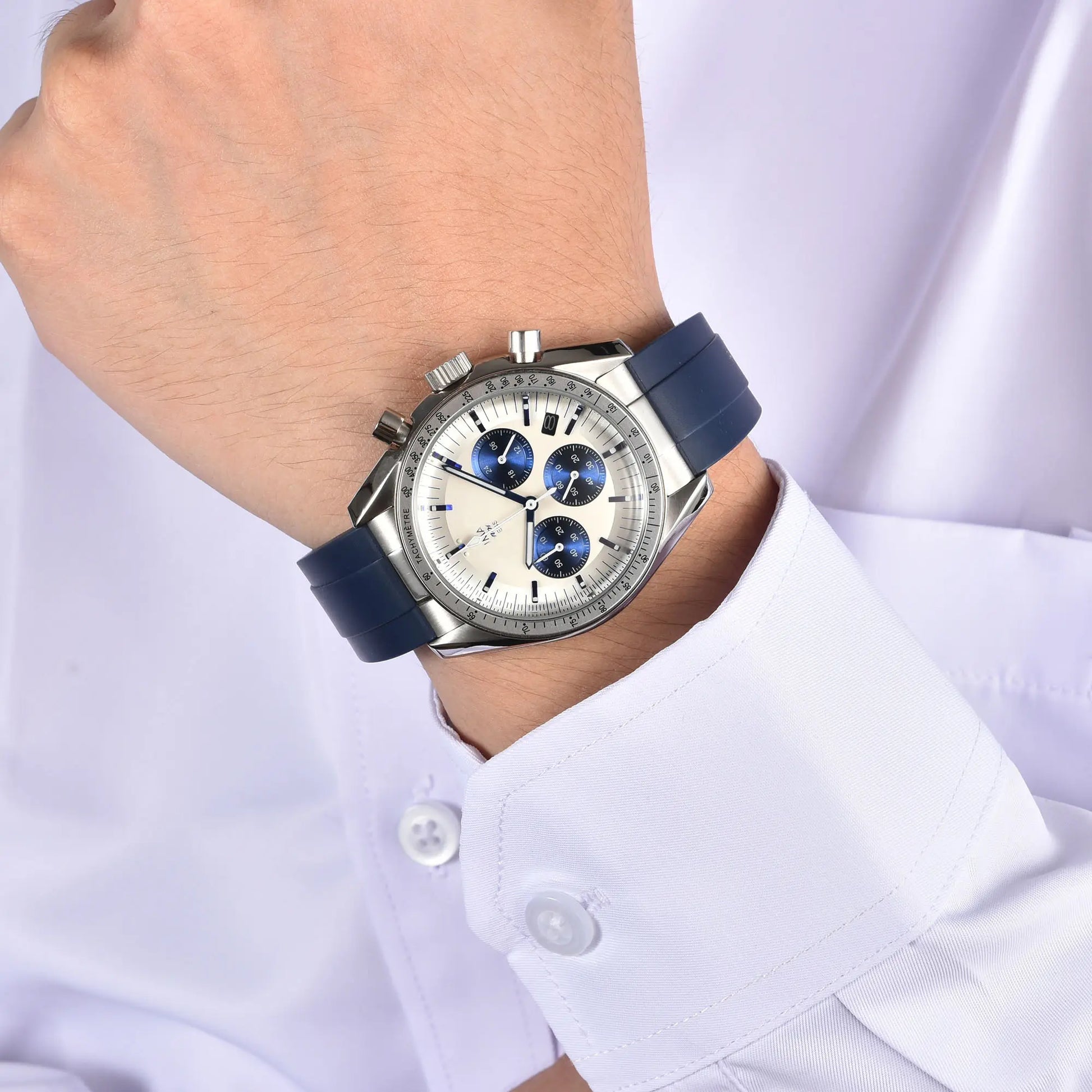 Silver blue chronograph speedmaster style Seiko mod watch on wrist, business lifestyle shot