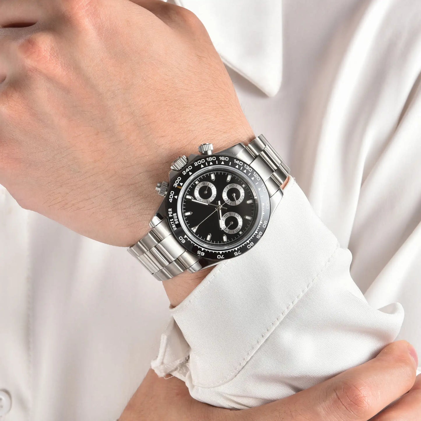Men's black panda VK63 Daytona style Seiko mod chronograph watch on wrist, business lifestyle shot