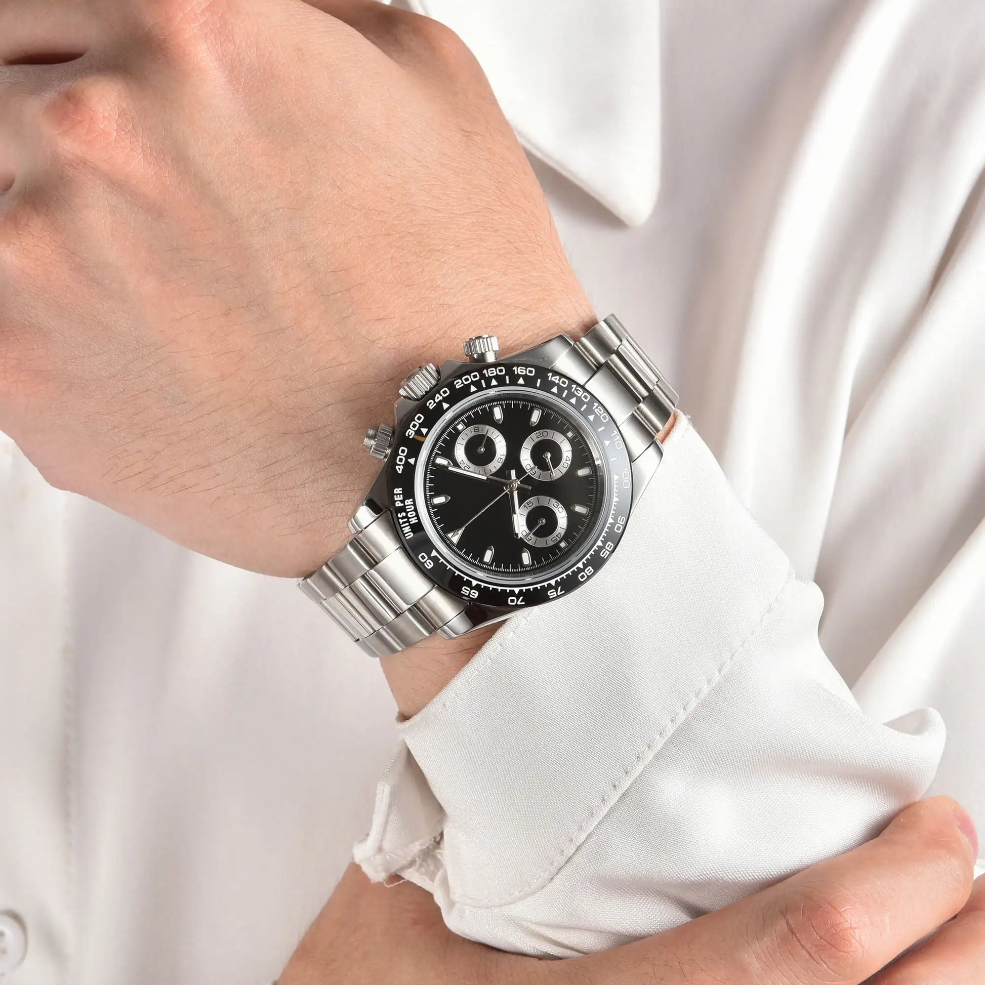 Men's black panda VK63 Daytona style Seiko mod chronograph watch on wrist, business lifestyle shot