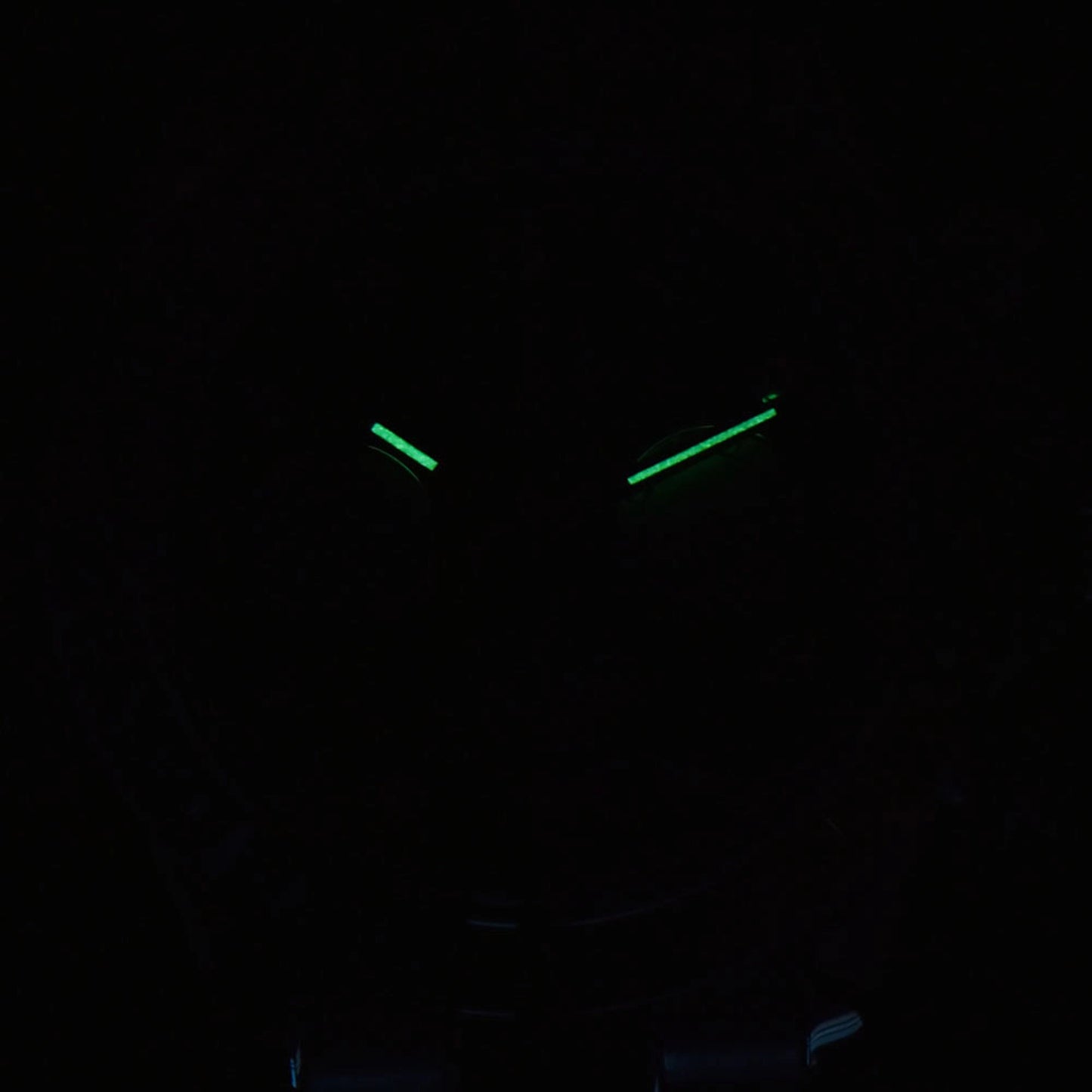 Luminous green hands of rainbow gem bezel Daytona style Seiko mod chronograph watch in dark environment