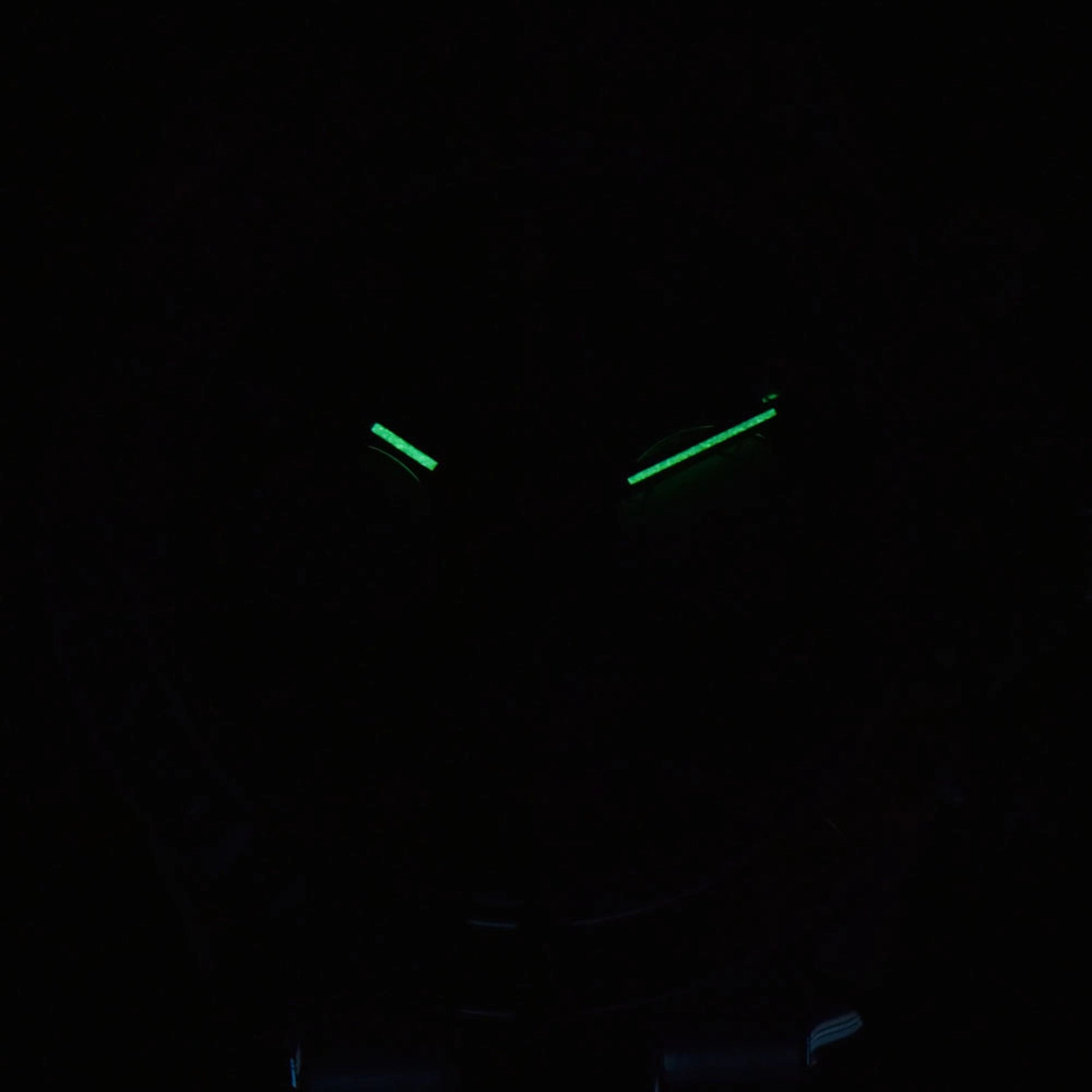 Luminous green hands of rainbow gem bezel Daytona style Seiko mod chronograph watch in dark environment