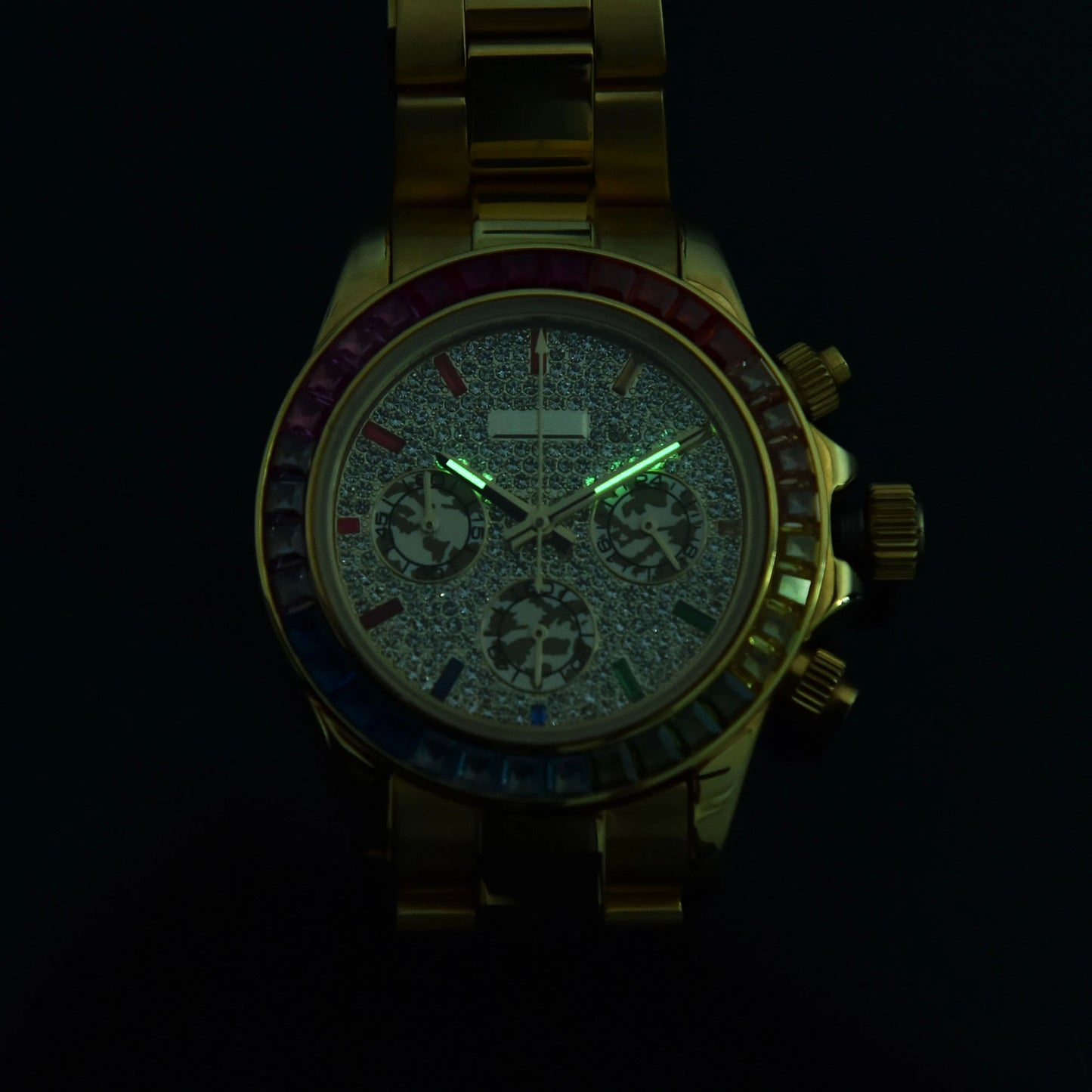 Luminous green hands of rainbow gem bezel Daytona style Seiko mod chronograph watch in dark environment