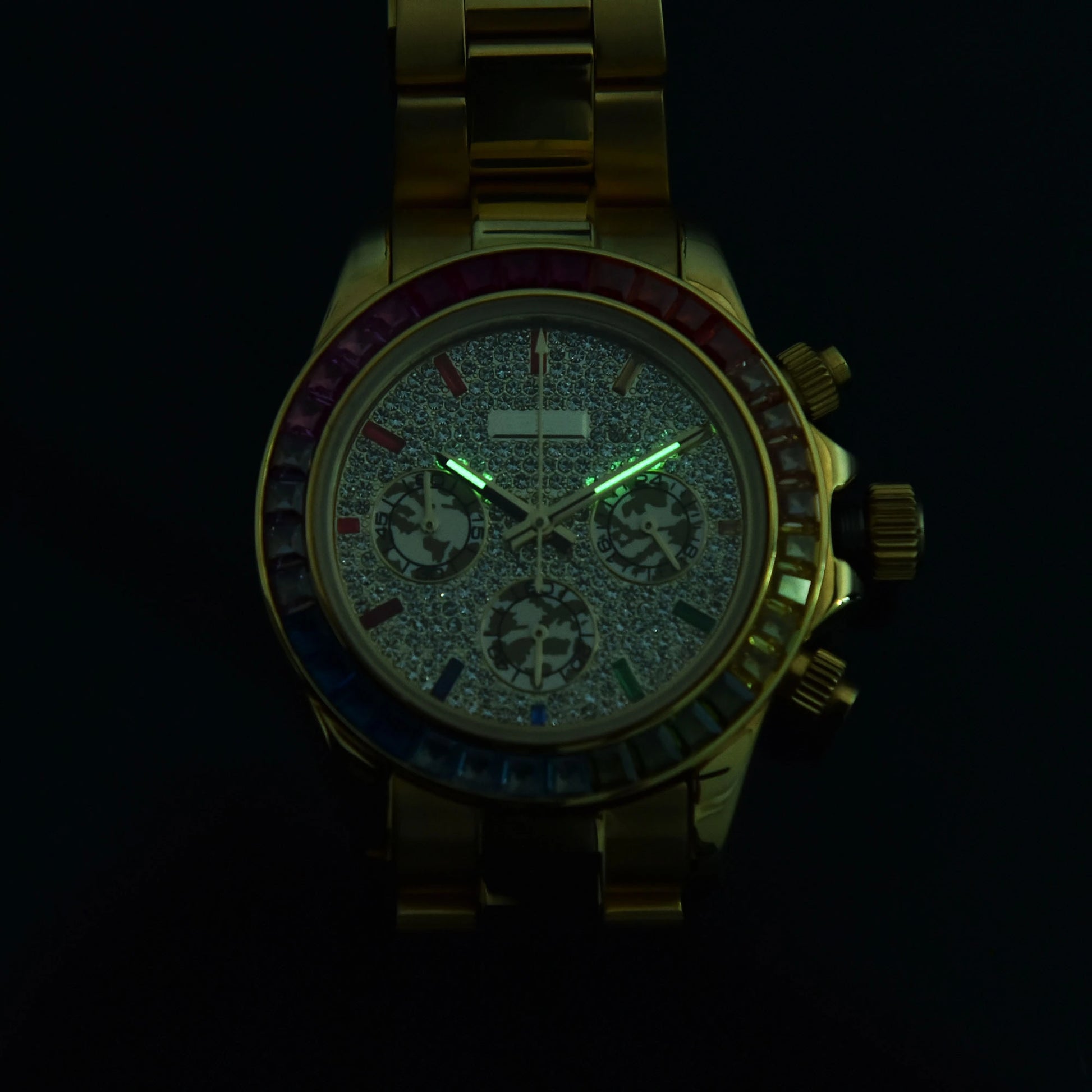 Luminous green hands of rainbow gem bezel Daytona style Seiko mod chronograph watch in dark environment