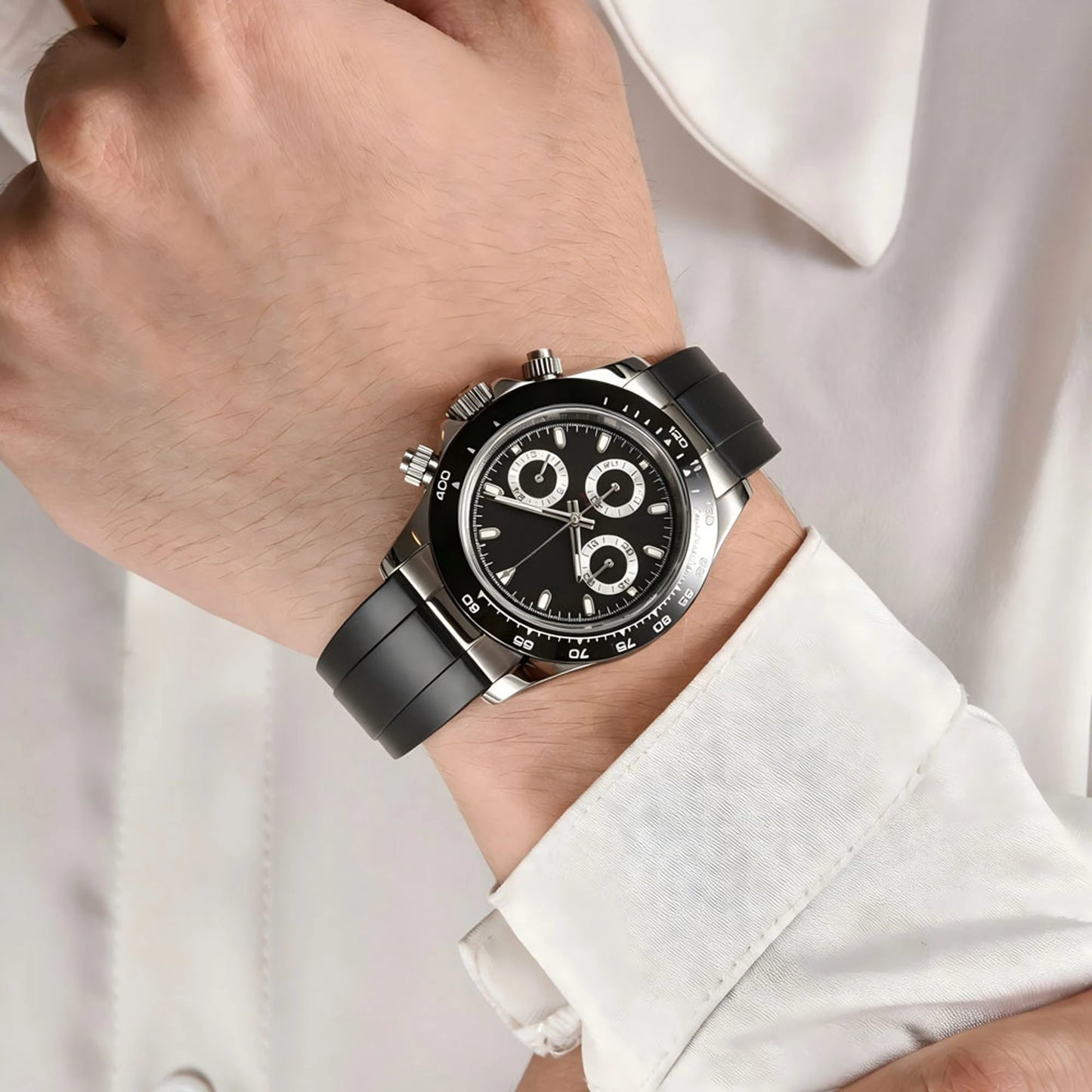 Men's black panda VK63 Daytona style Seiko mod chronograph watch on wrist, business lifestyle shot