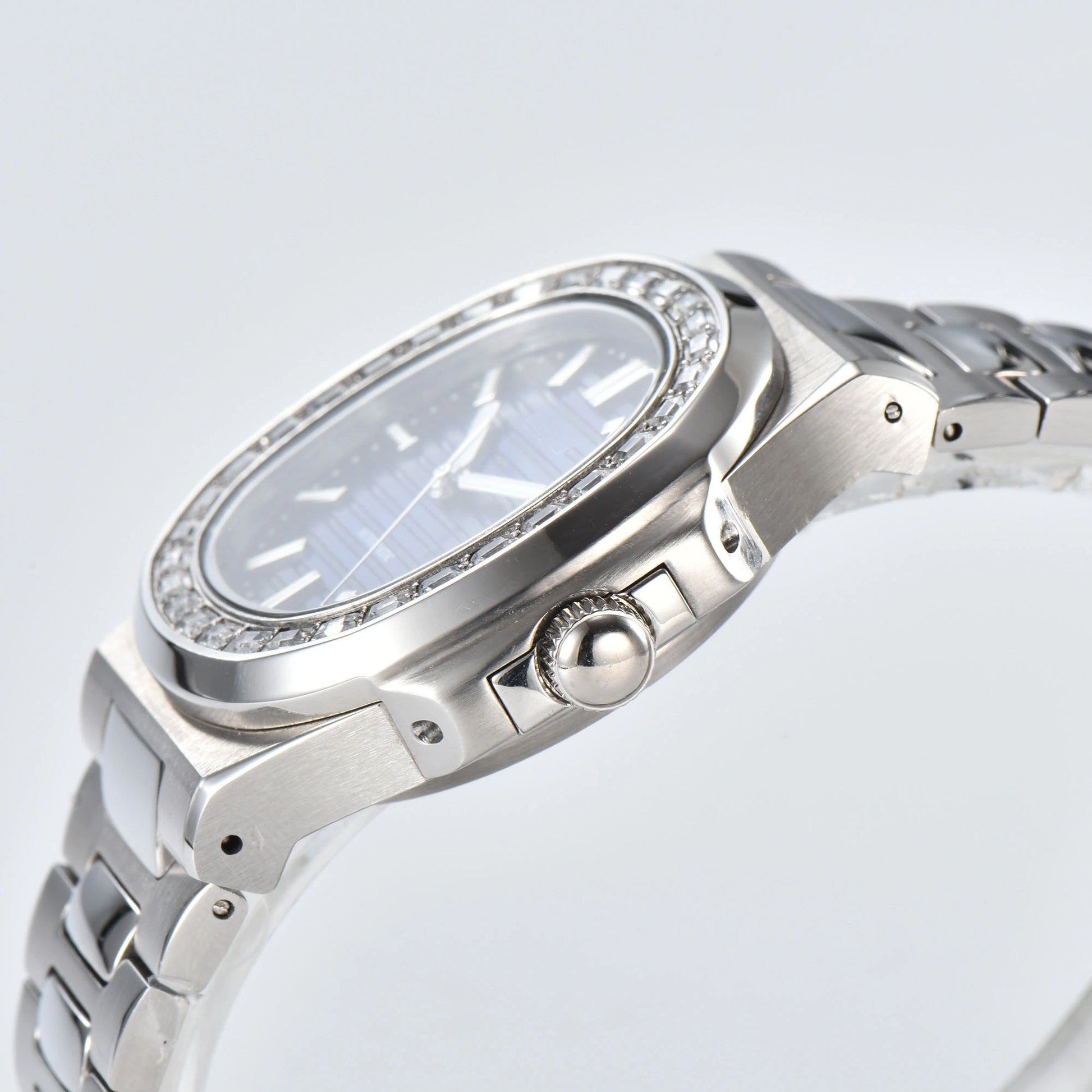 Side view of diamond bezel Nautilus style Seiko mod watch, polished stainless steel case and crown detail