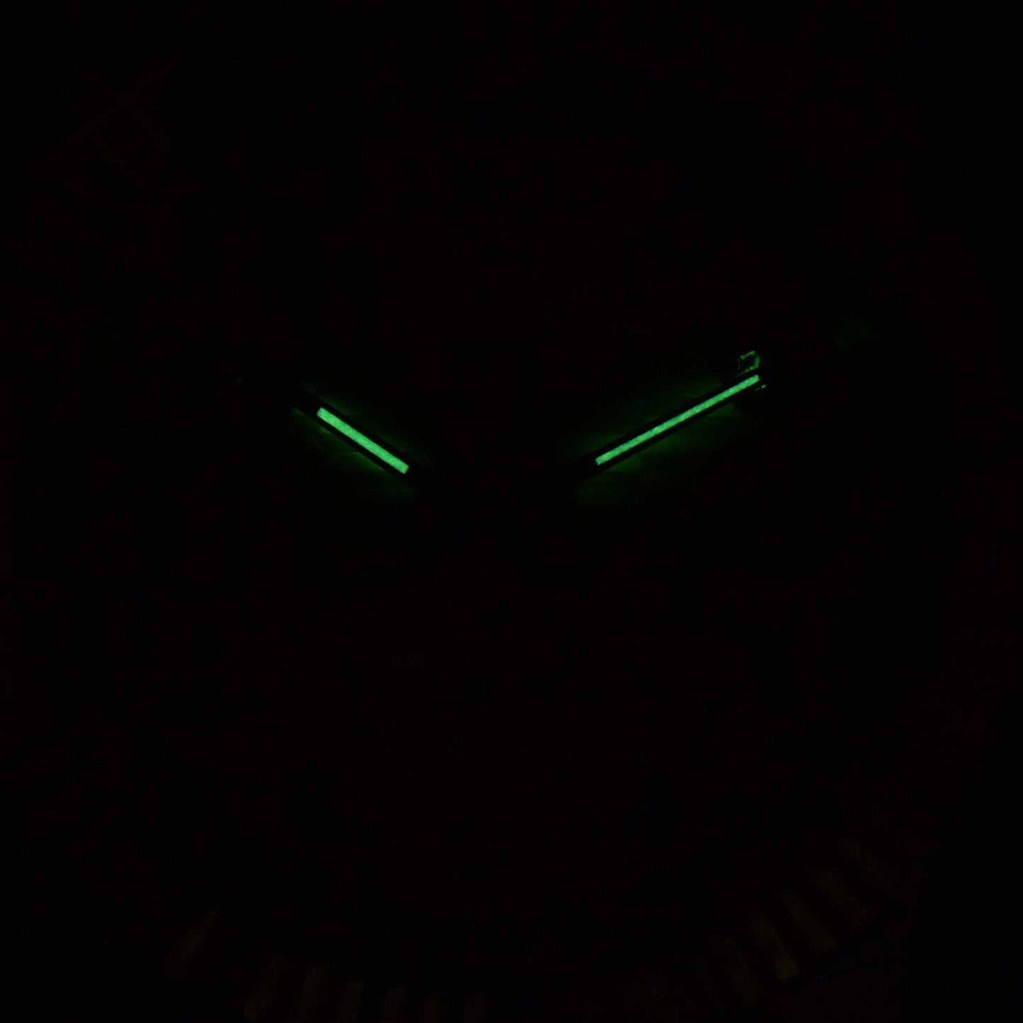 Low light close-up of Seiko mod watch hands showing strong C3 Super-LumiNova 