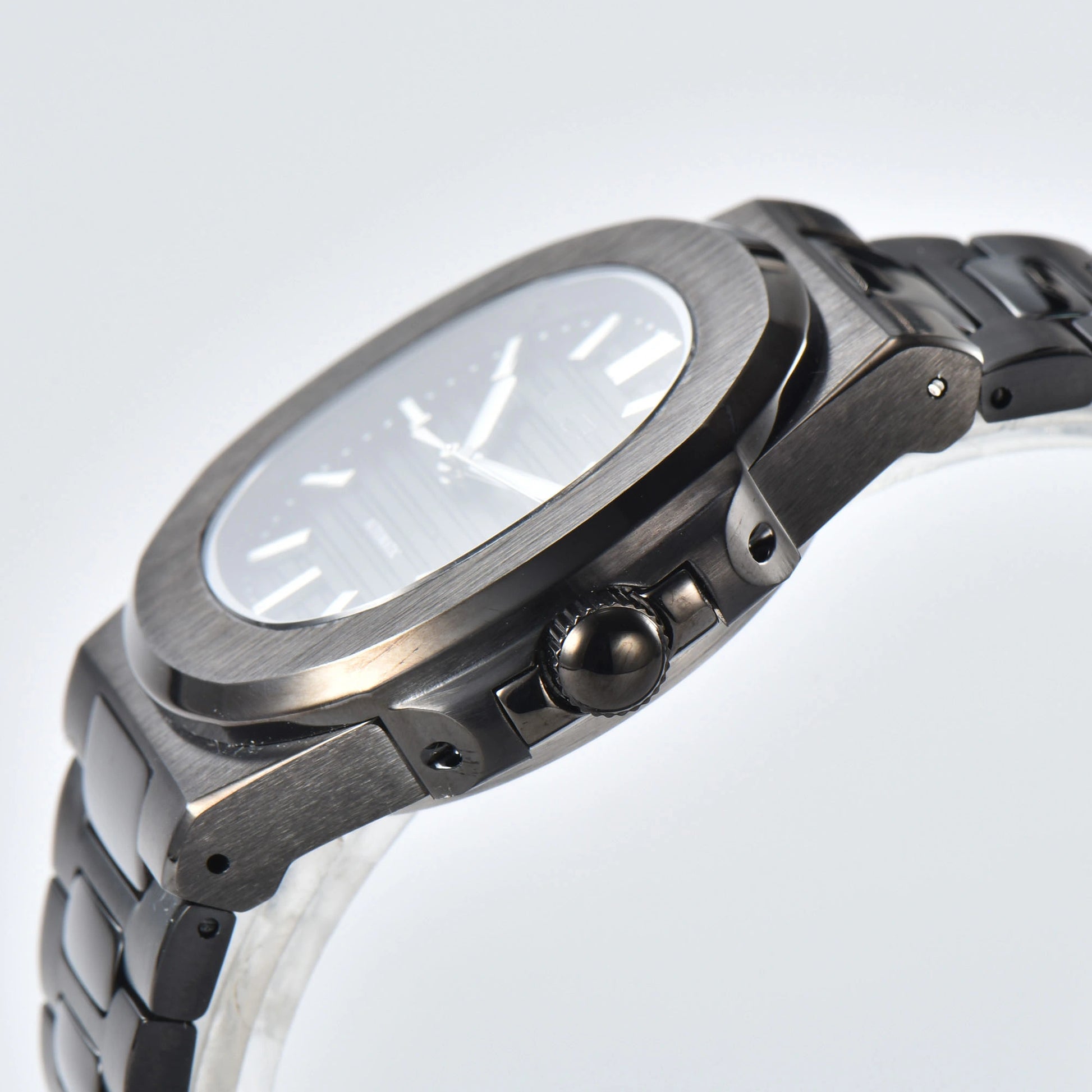 Side view of Nautilus style Seiko mod watch, polished stainless steel case and black crown detail
