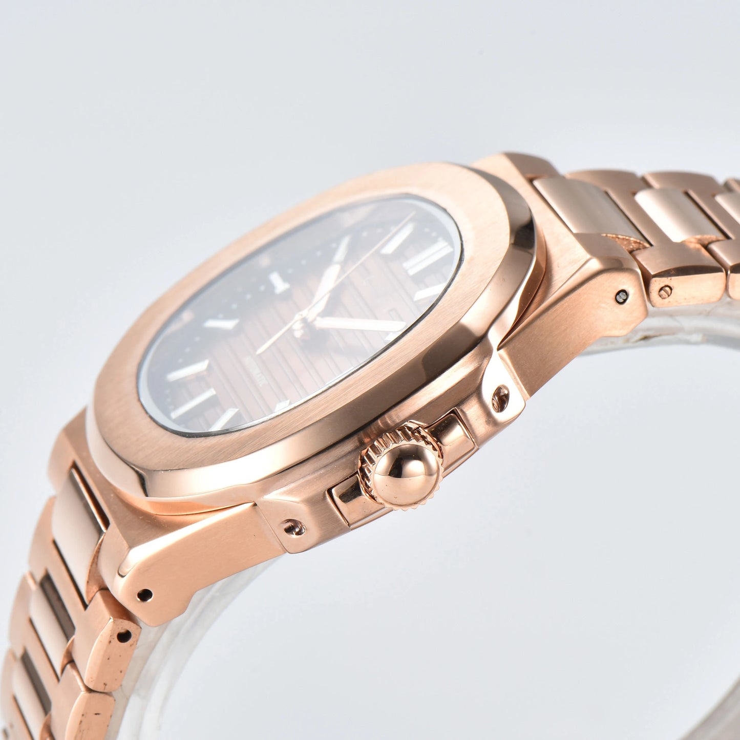 Side view of Nautilus style Seiko mod watch, polished stainless steel case and rose gold crown detail
