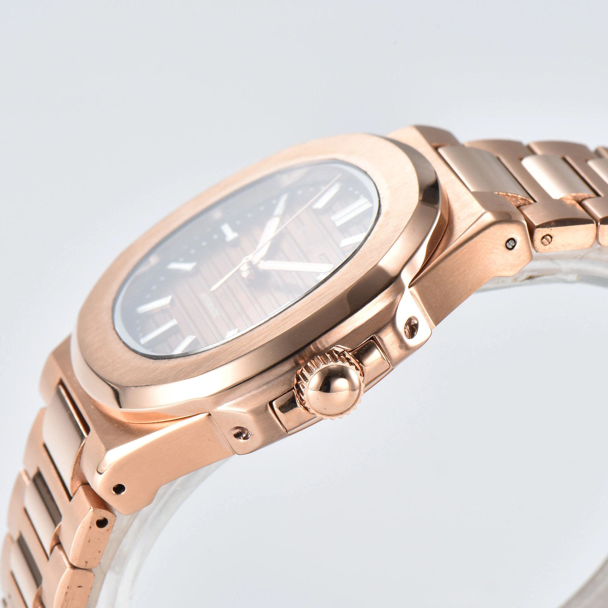 Side view of Nautilus style Seiko mod watch, polished stainless steel case and rose gold crown detail