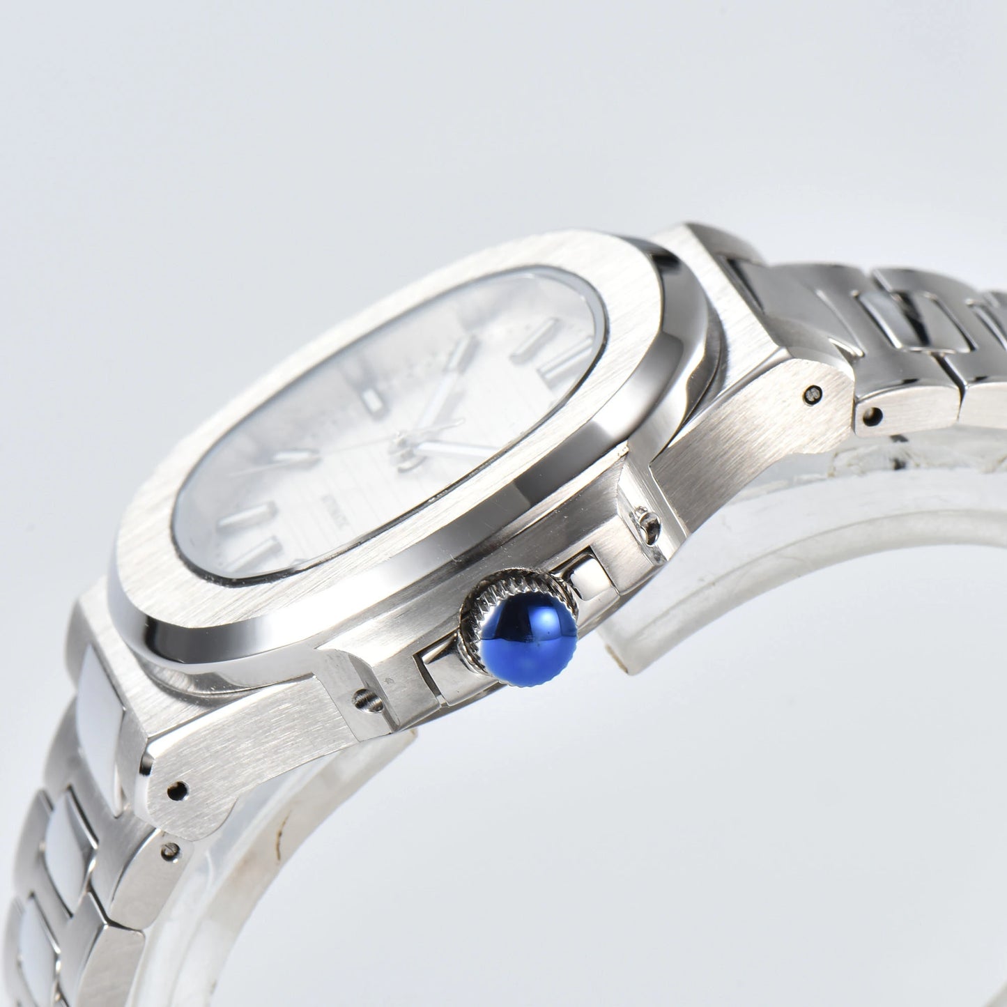 Side view of Nautilus style Seiko mod watch, polished stainless steel case and silver crown detail